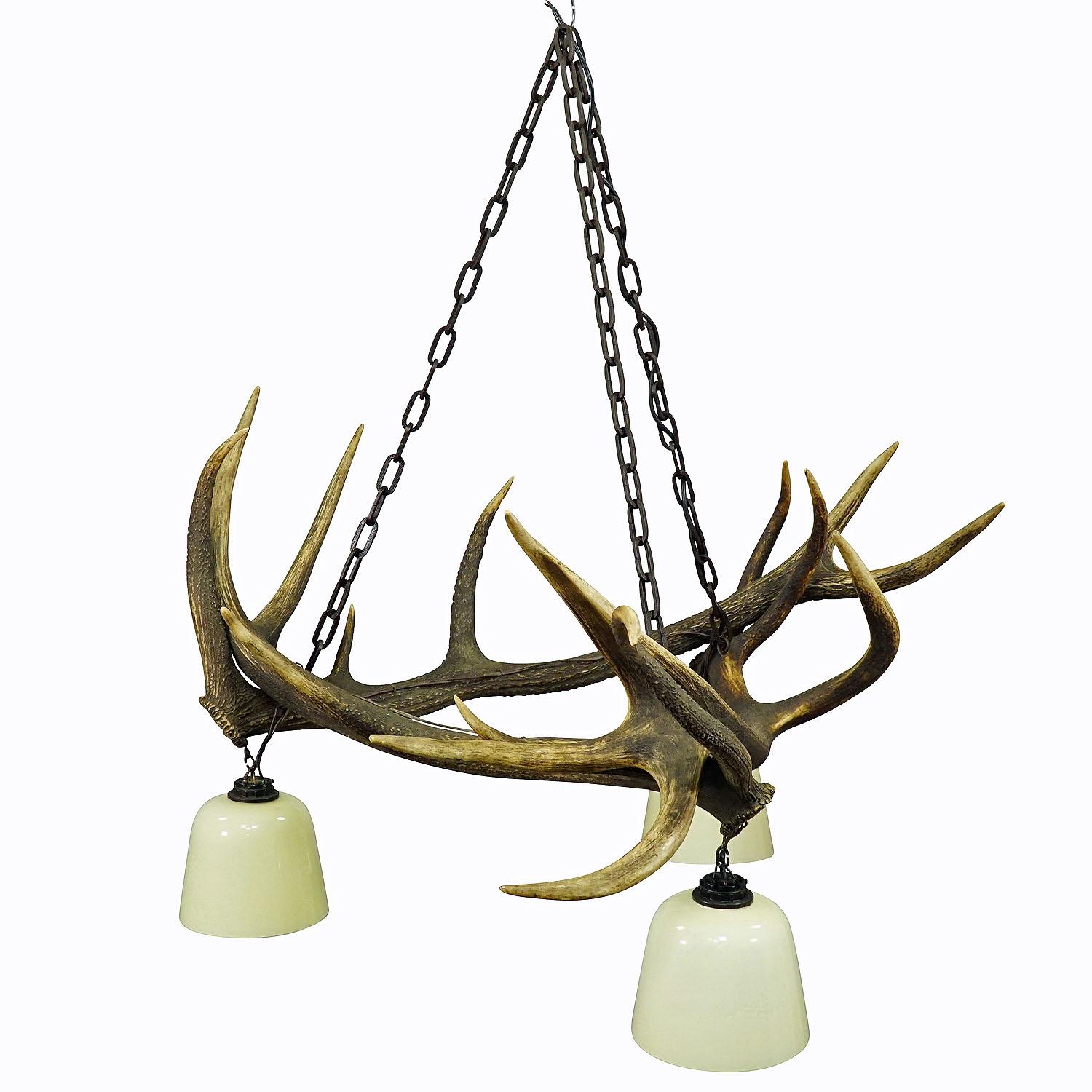 Rustic antler lamp with deer Antlers

A large antler chandelier made of three joined deer antlers. The lamp comes with 3 spouts, vintage glass shades and a handforged iron chain suspension. Manufactured in Germany ca. 1960.

Antler furniture have