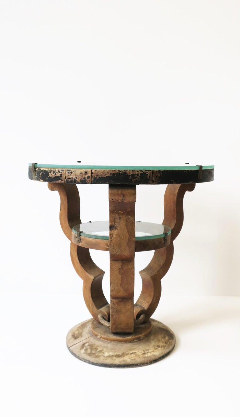 A small rustic Art Deco style round wood and glass side or drinks table, circa late-20th century, Europe. This side or drinks table has all the hallmarks of the Deco design style including its round top with cut interior, round interior