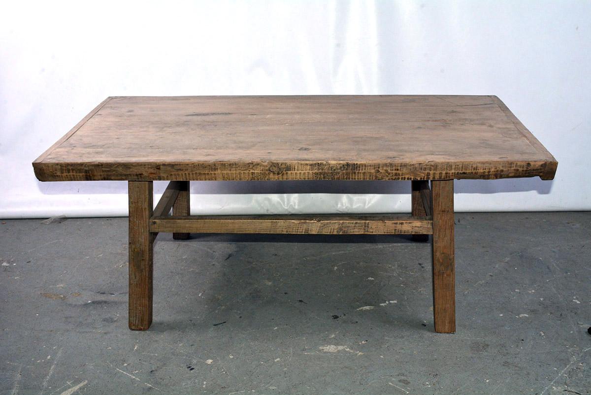 The rustic Asian coffee table with bread-board ends also works just as well as a bench for extra seating at just the right height. The thick planks are secured underneath with a pair of cross pieces partially fitted into grooves. The simplicity of
