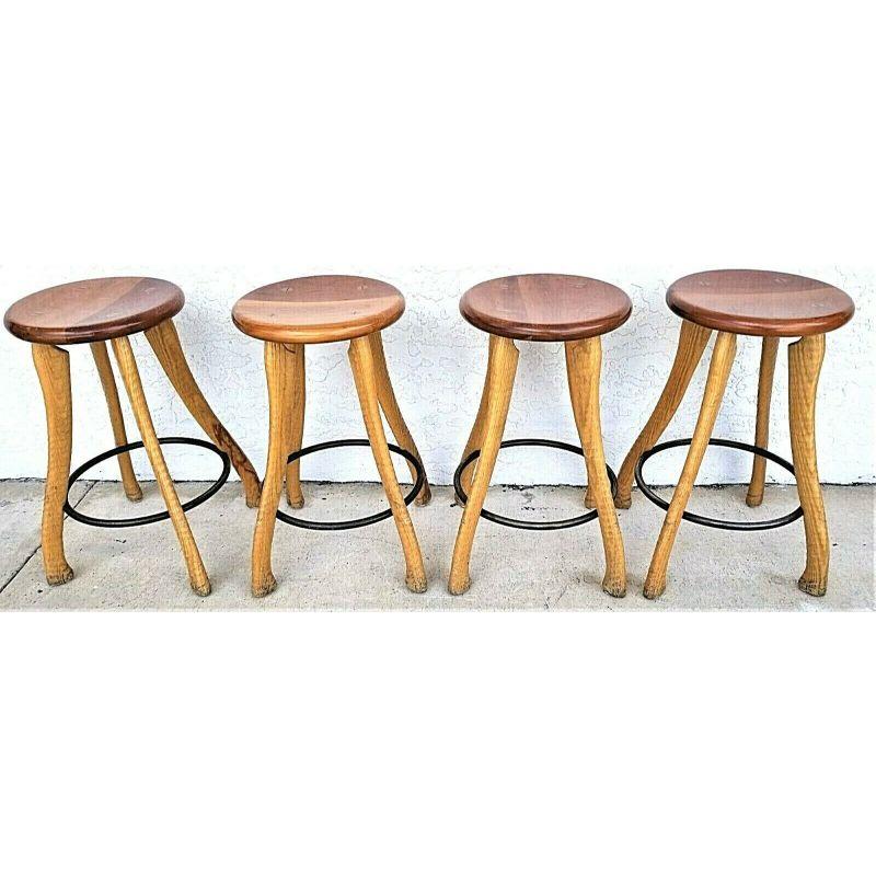 Offering one of our recent palm beach estate fine furniture acquisitions of 
Set of 4 Rustic Ax Handle counter stools cherry seats steel footrests 

Dramatically ribbed legs made from lathe-turned ash ax handles are through tenoned to cherry