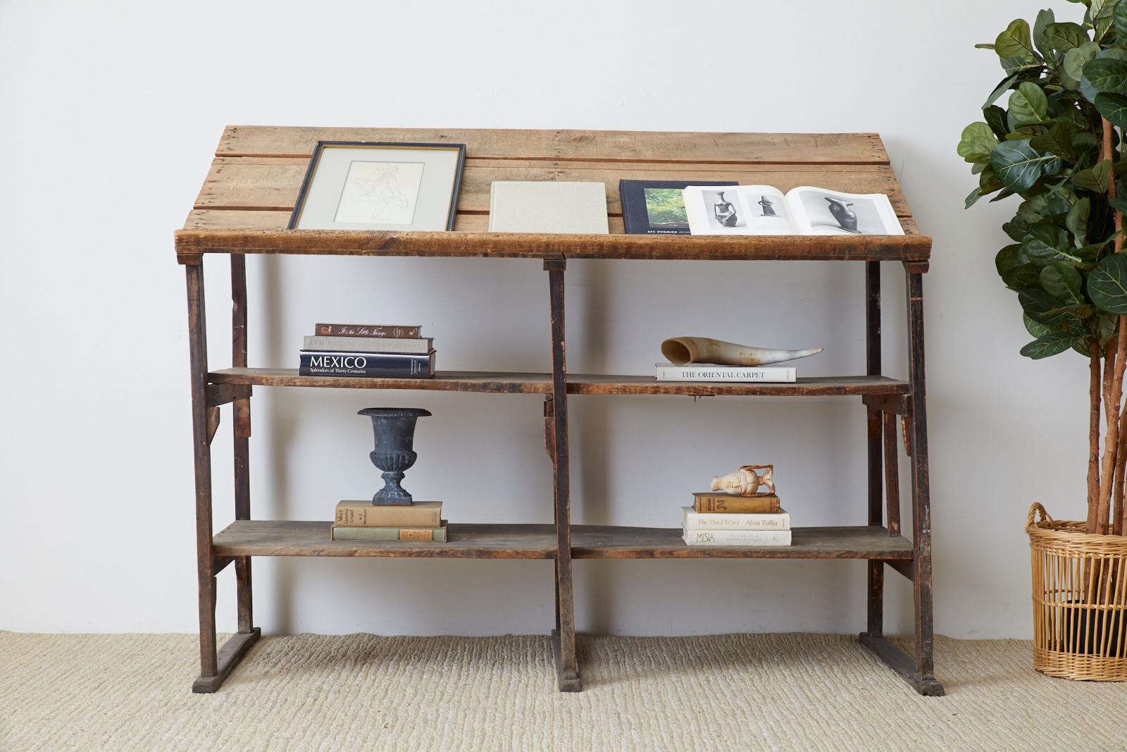 Large early 20th century American rustic three shelf display or étagère. Constructed from weathered pine barnwood with a lovely distressed patina. The open frame holds three shelves with the top set at an angle having a lip on the bottom. Perfect