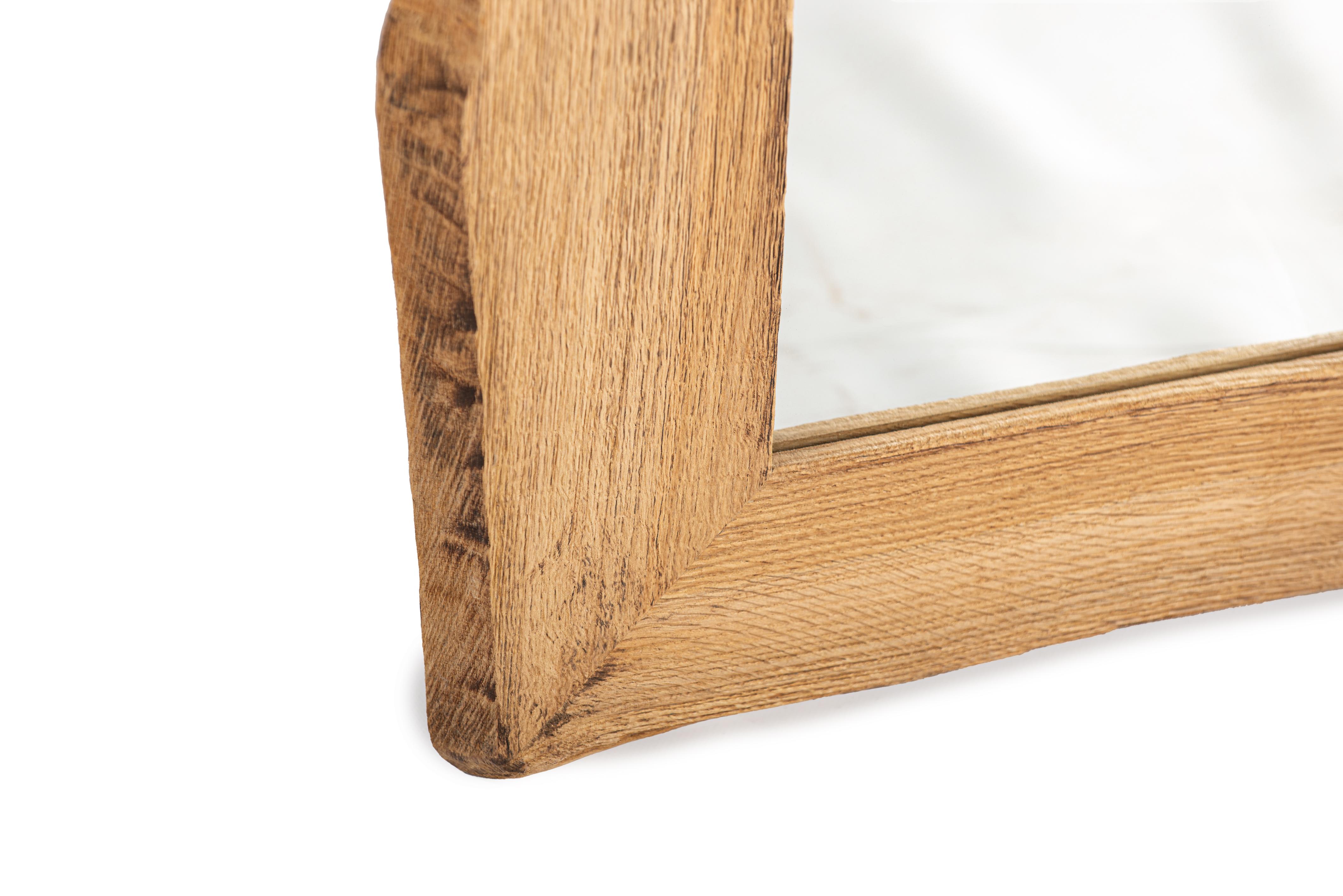 
This rustic-style log mirror was recently crafted in our workshop. The frame features a clean, rectangular inner edge, while the outer edge retains the natural, rugged sides of the tree, also known as a live edge. Made from European summer oak, the