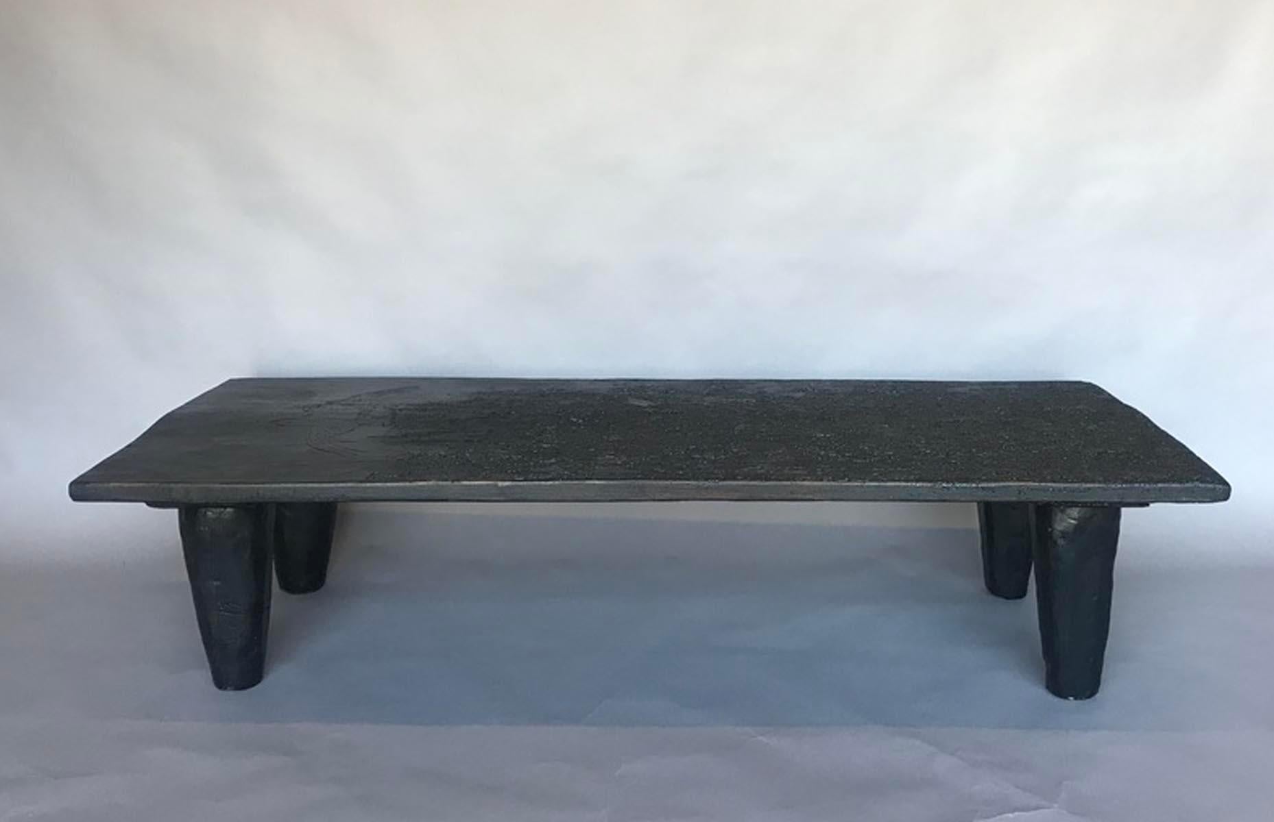 Rustic modern coffee table with a 19th century top and newly made conical shaped legs. The top has old termite damage which has given it a very interesting patina! no live bugs, we have everything fumigated. There are two birds carved into the wood.