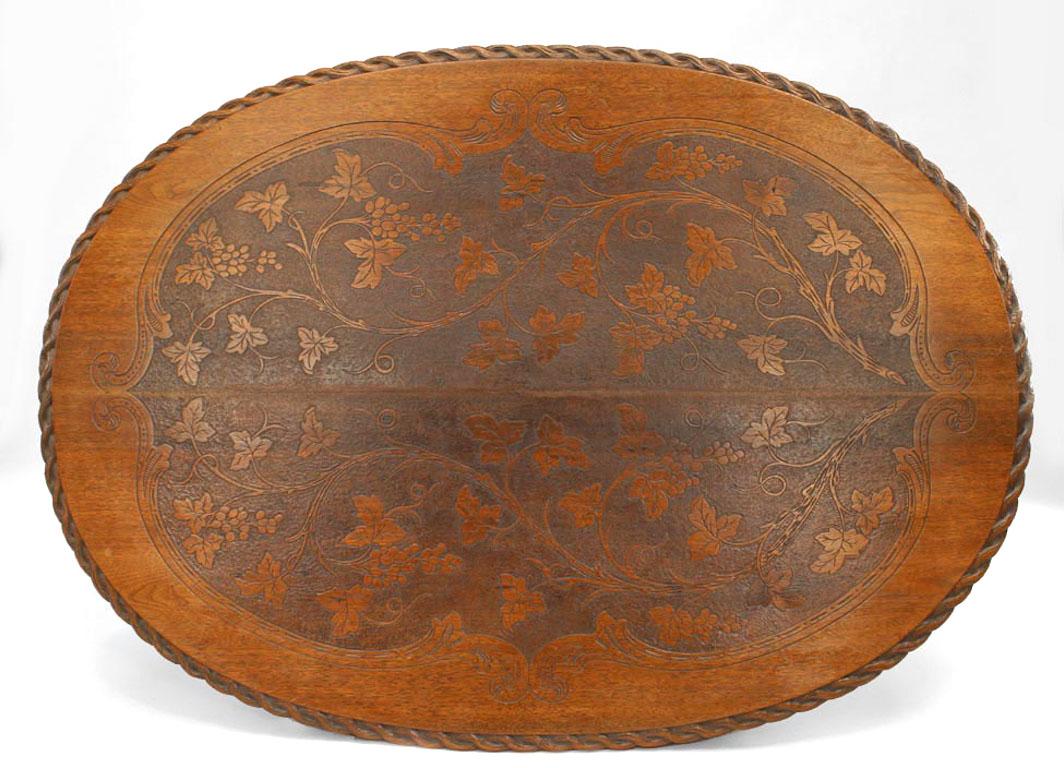 Rustic black forest (19th century) walnut oval dining table with carved faux wood design base and etched floral design top with carved rope edge.
  