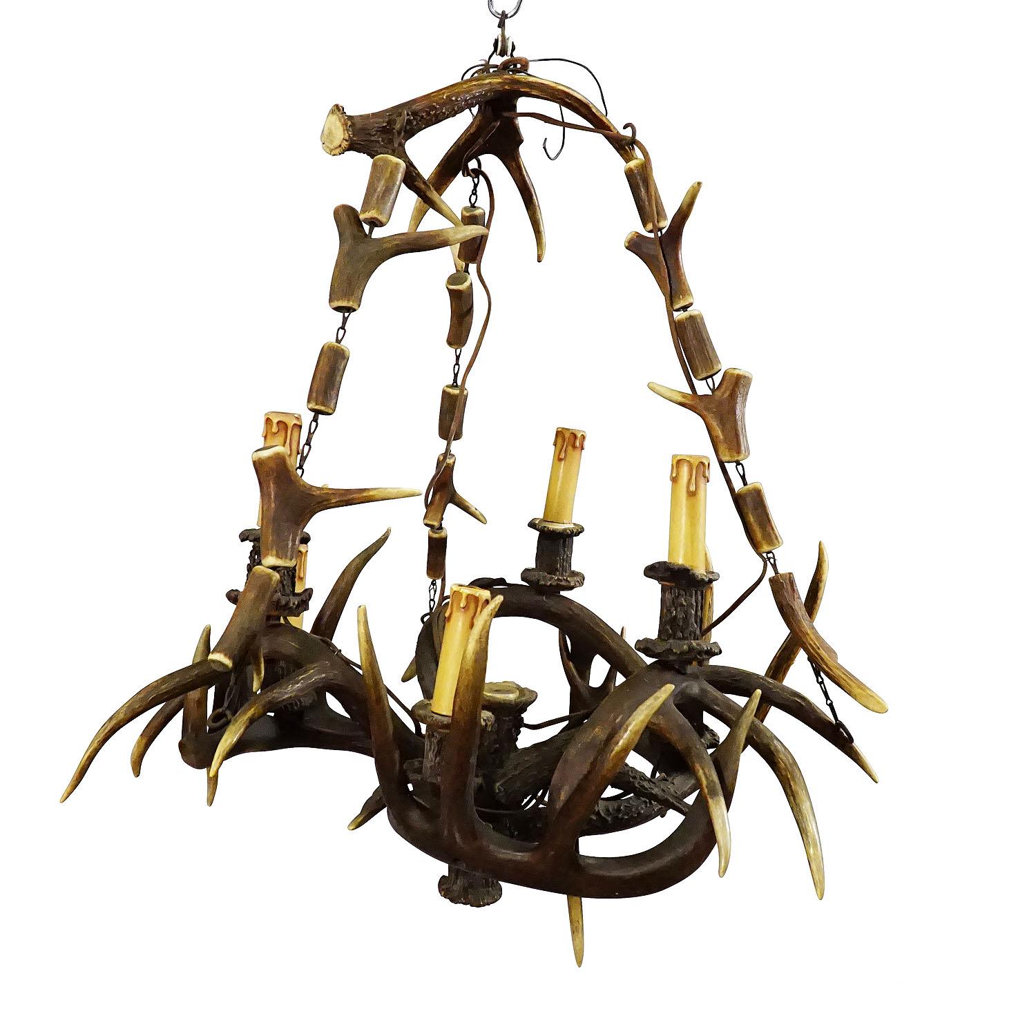 Rustic Black Forest Antler Chandelier ca. 1900

An antique rustic antler chandelier made of original deer and virginia deer antlers. Manufactured in Germany around 1900. The chandelier features 6 electrified spouts in candle design. The original