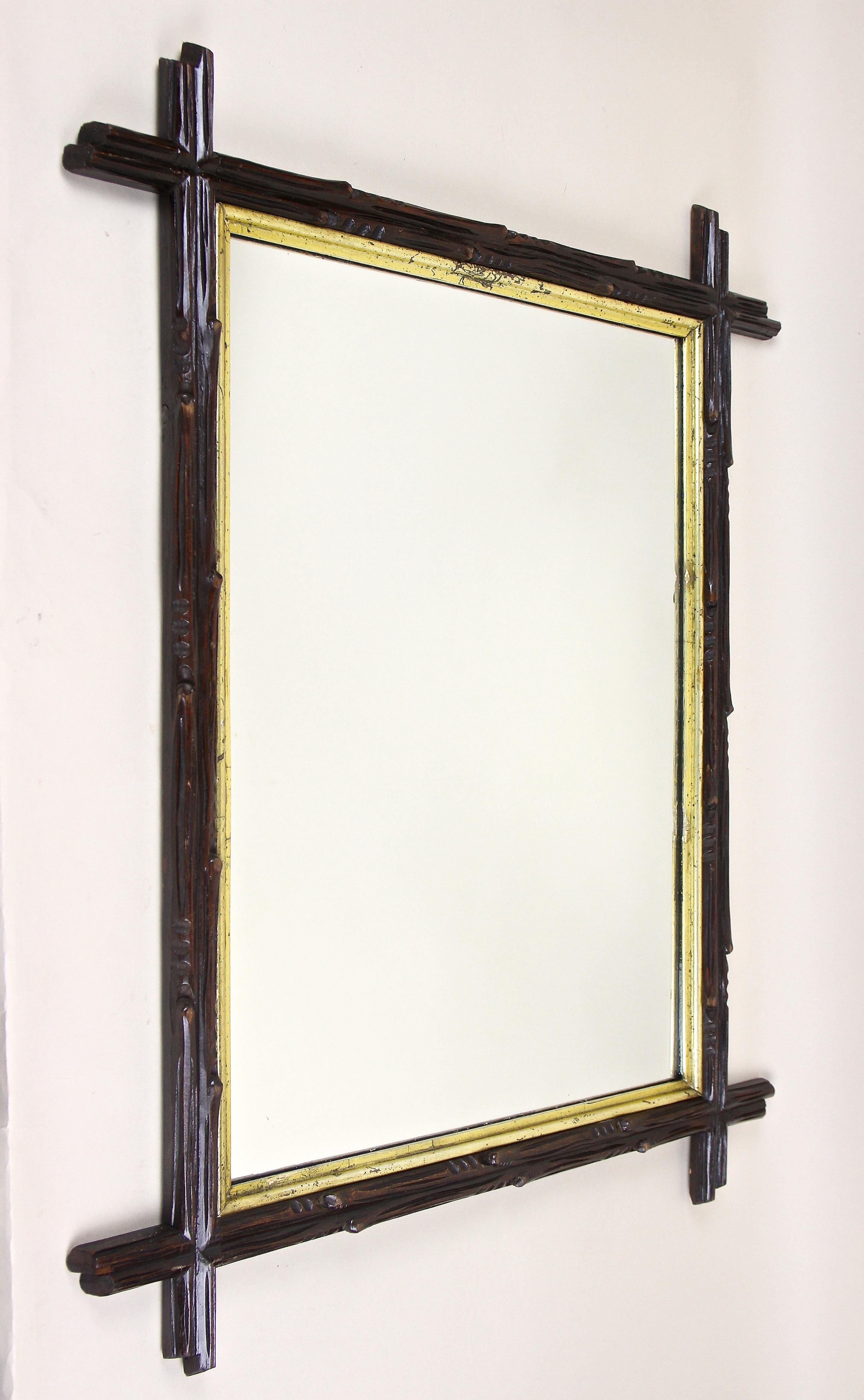 Charming rustic black Forest wall mirror from the period in Austria around 1880. Artfully hand carved out of basswood, this exceptional rural mirror impresses with its gorgeous carved frame in the style of tree branches, slightly protruding corners