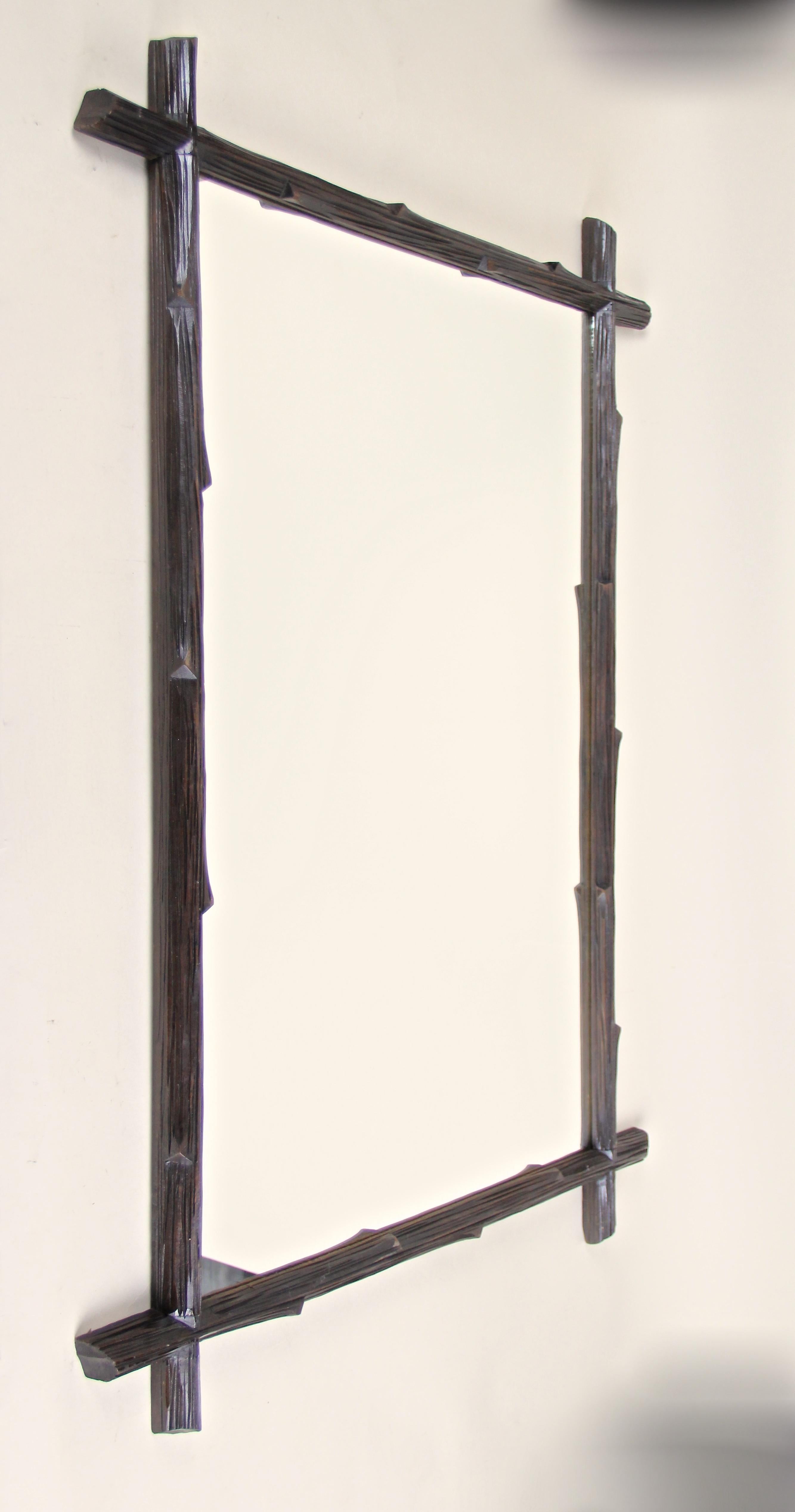 Large rustic Black Forest wall mirror from the late 19th century in Austria. The simple but beautiful design processed circa 1880 brings a unique rural charme to your home. This hand carved Black Forest mirror shows a fantastic 