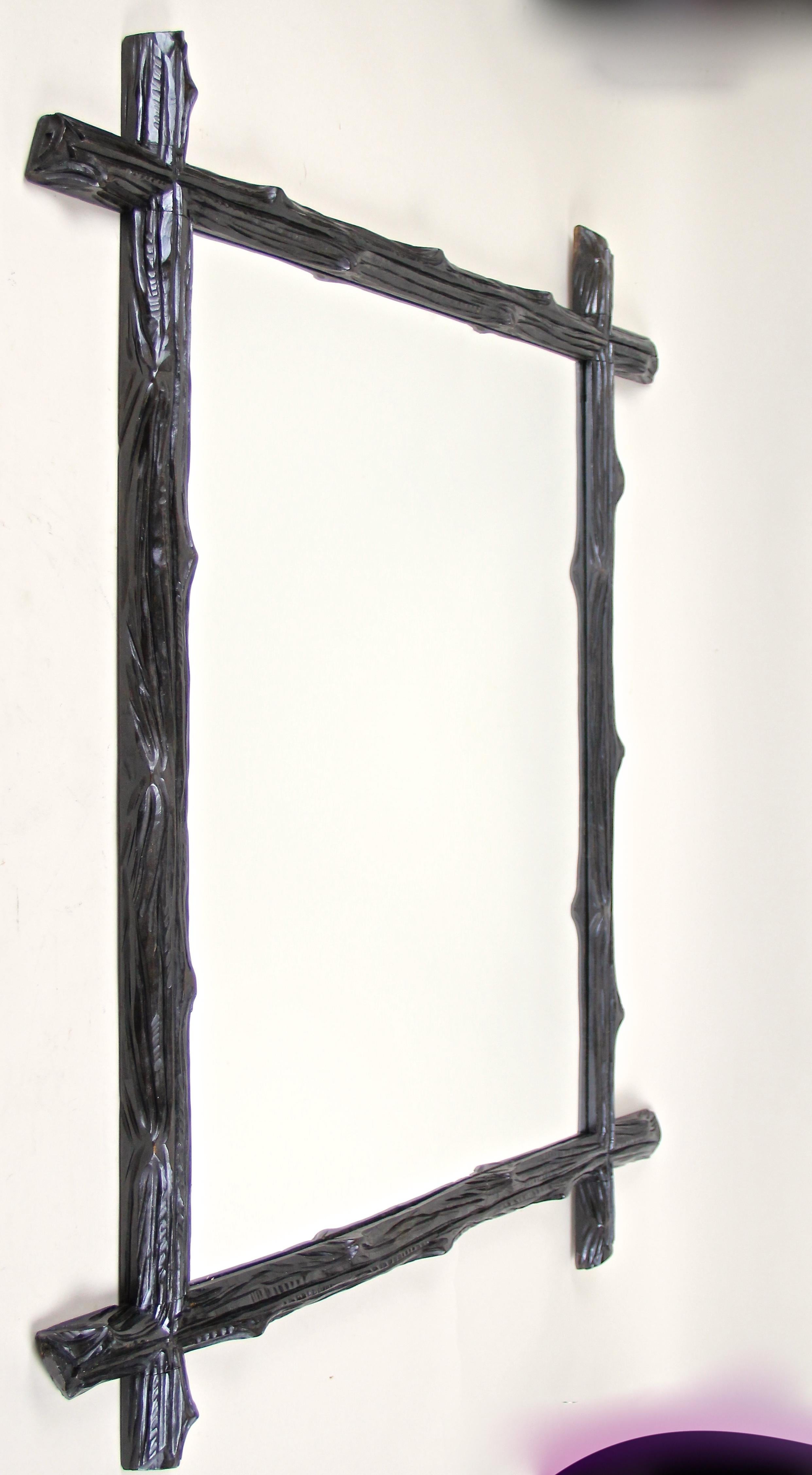 Large rustic designed Black Forest wall mirror from Austria, circa 1880. This antique wall mirror impresses with a simple but elegant 
