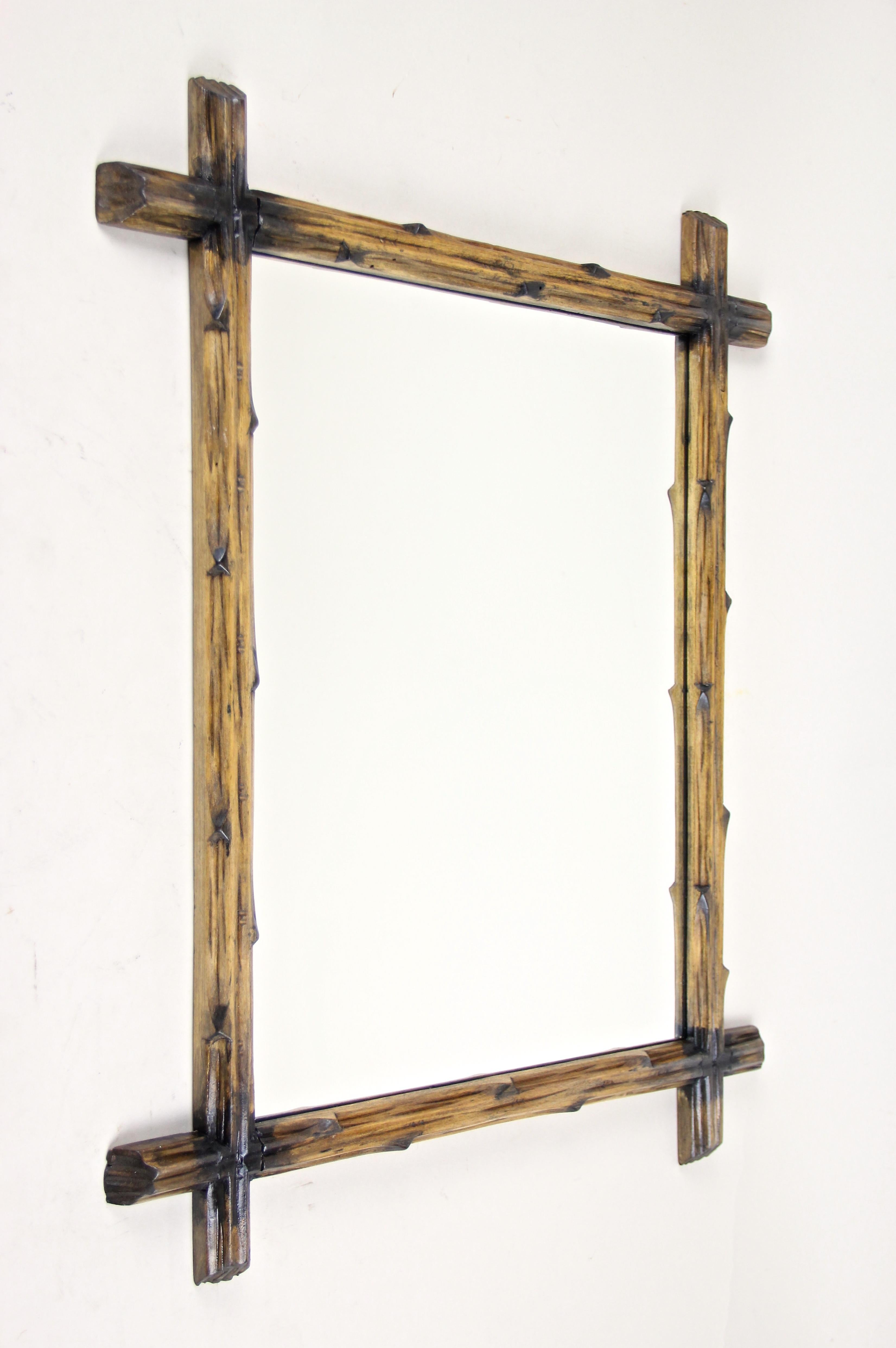 Unusual rustic Black Forest wall mirror out of Austria. From circa 1890 comes this lovely hand carved Black Forest wall mirror with a simple but elegant design, created out of basswood and showing the typical 