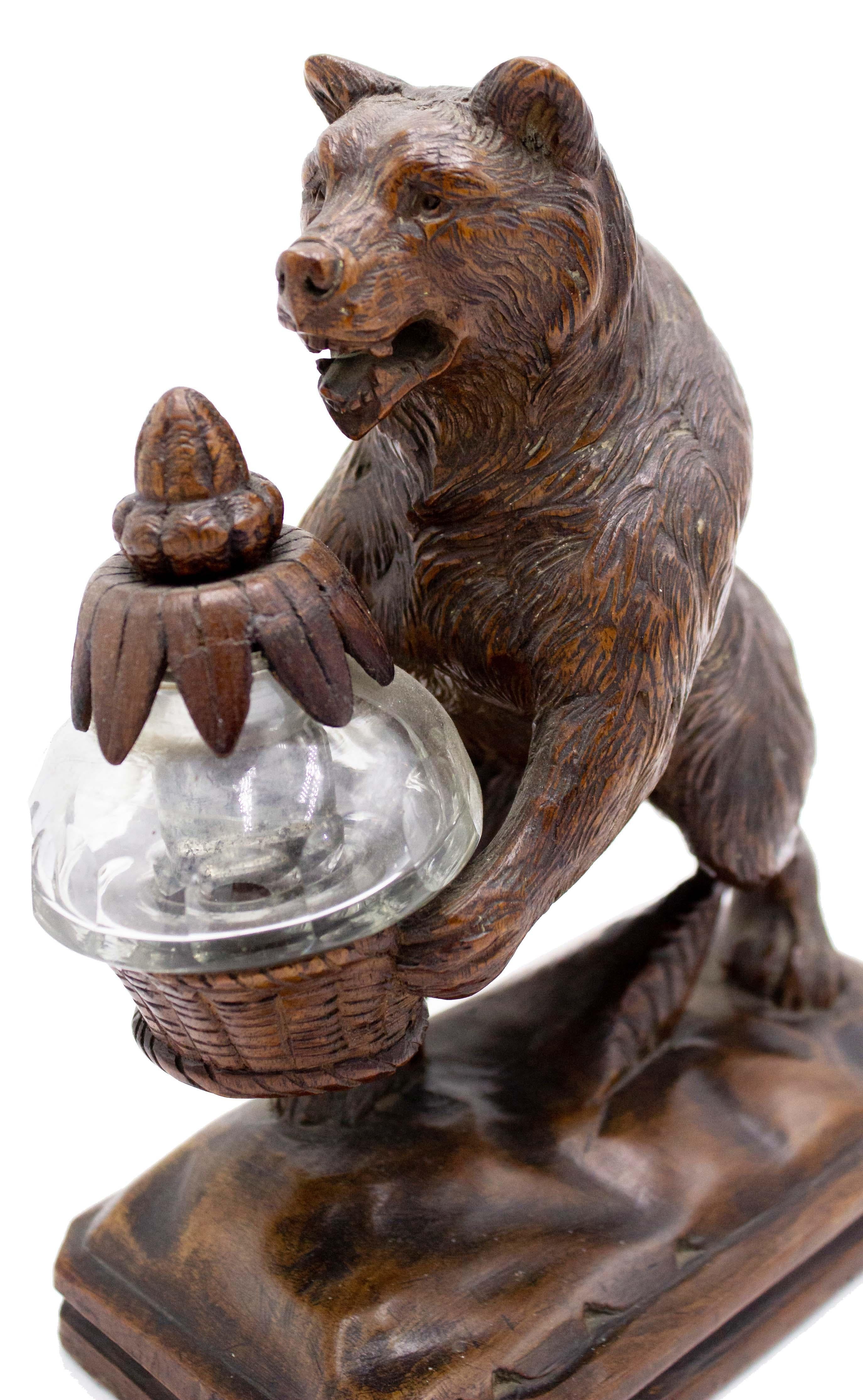 Rustic black forest (19th Century) walnut figure of bear holding crystal inkwell in carved woven basket with acorn top.
 