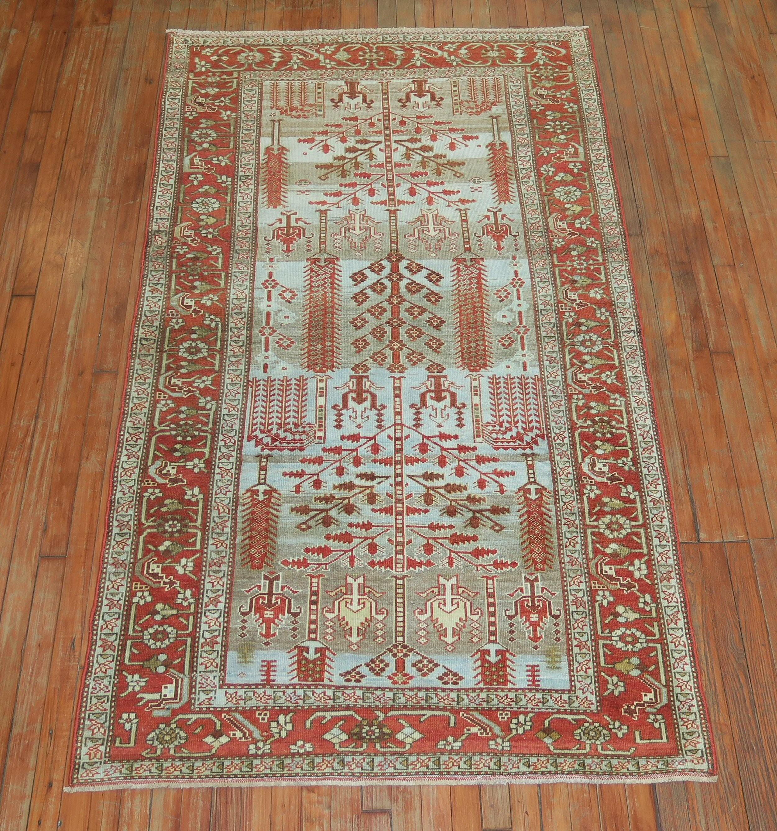 Early 20th century Persian Malayer rug featuring a weeping willow tree of life motif on a powder blue ground with striations of brown mixed in. The border is in the rust color family. Great condition overall.

circa 1920, measures: 4'2