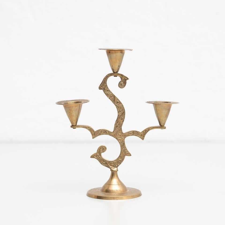 Rustic brass candle holder, circa 1950
By unknown manufacturer, made in Spain

In original condition, with minor wear consistent with age and use, preserving a beautiful patina.
  
Material:
Brass.

