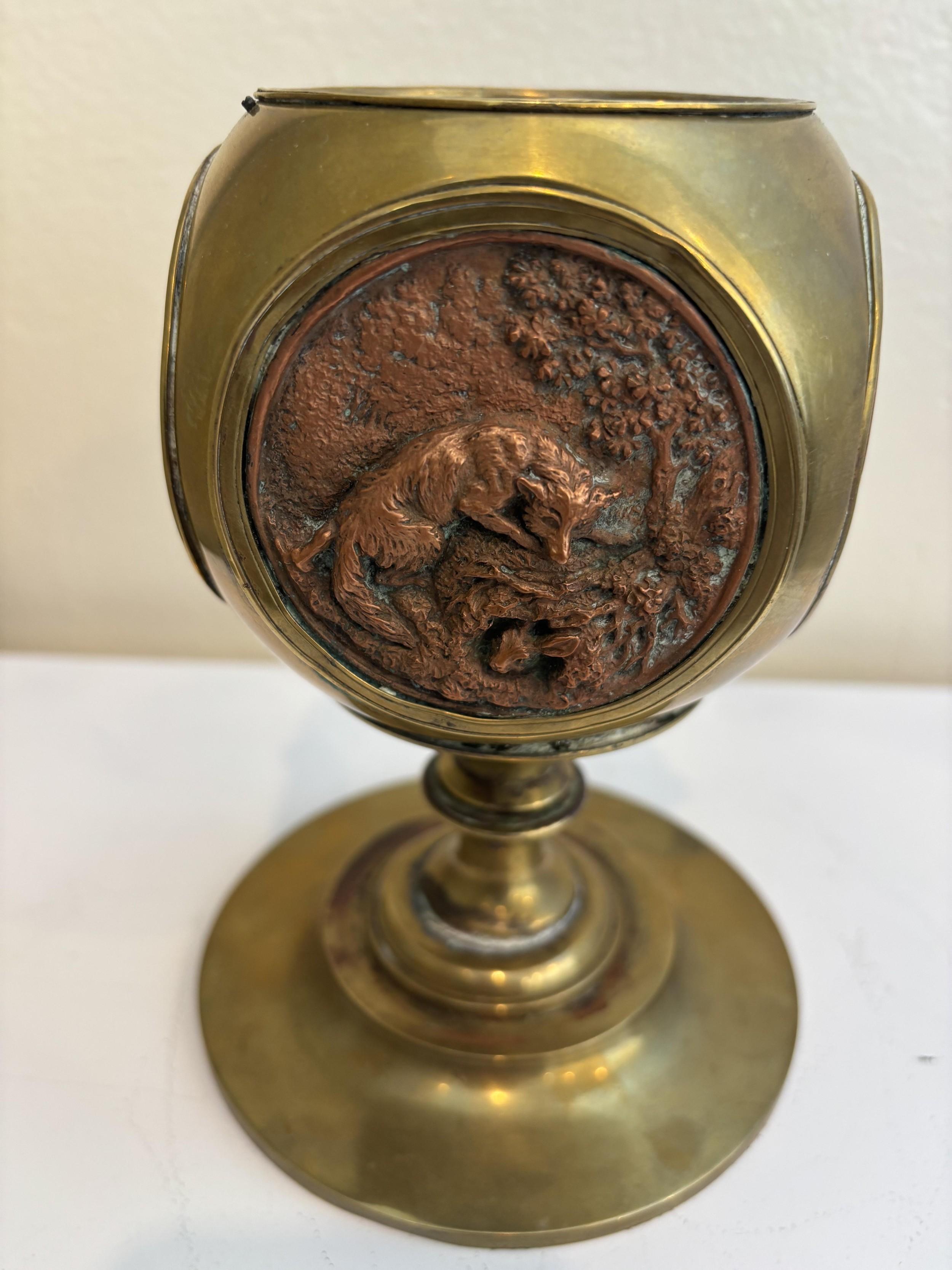 Continental Rustic (possibly German) late 19th Century brass container / cashpot having 4 copper medalions of animals and hunting scenes resting on a round base