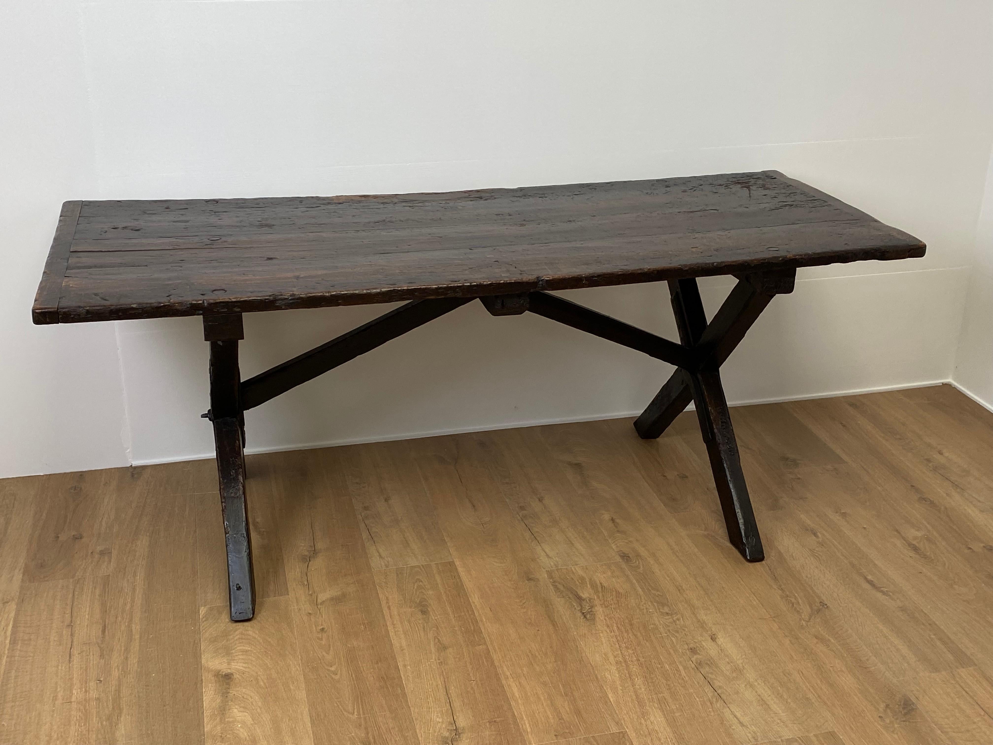 Beautiful Brutalist and rustic, antique English tavern table,
England around 1920,
Very nice old patina and warm and worn shine of the Pine Wood,
One leg has his inscriptions,
Can be used as a table or as a writing desk.
   