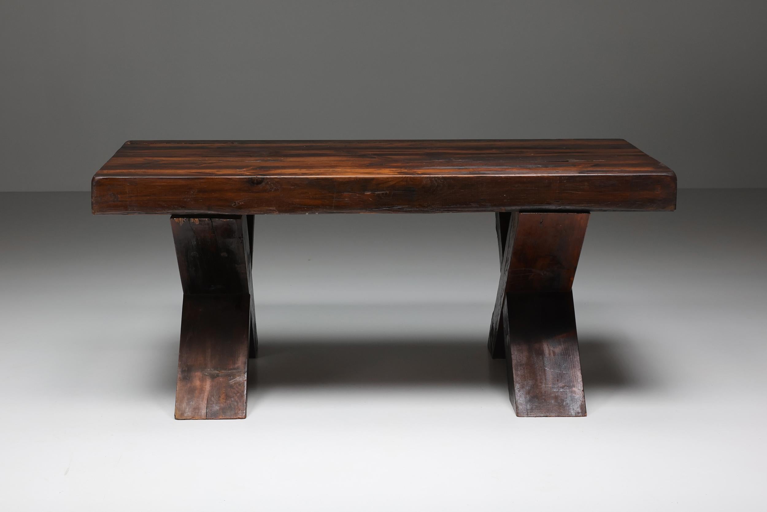 Mid-Century Modern; Italy; Rustic; Brutalist dark wooden dining table with x-legs, Italy, the 1940s; 

Rustic dark wooden dining table with X-shaped legs made in Italy in the 1940s. Seats six people comfortably. The table has a charismatic patina