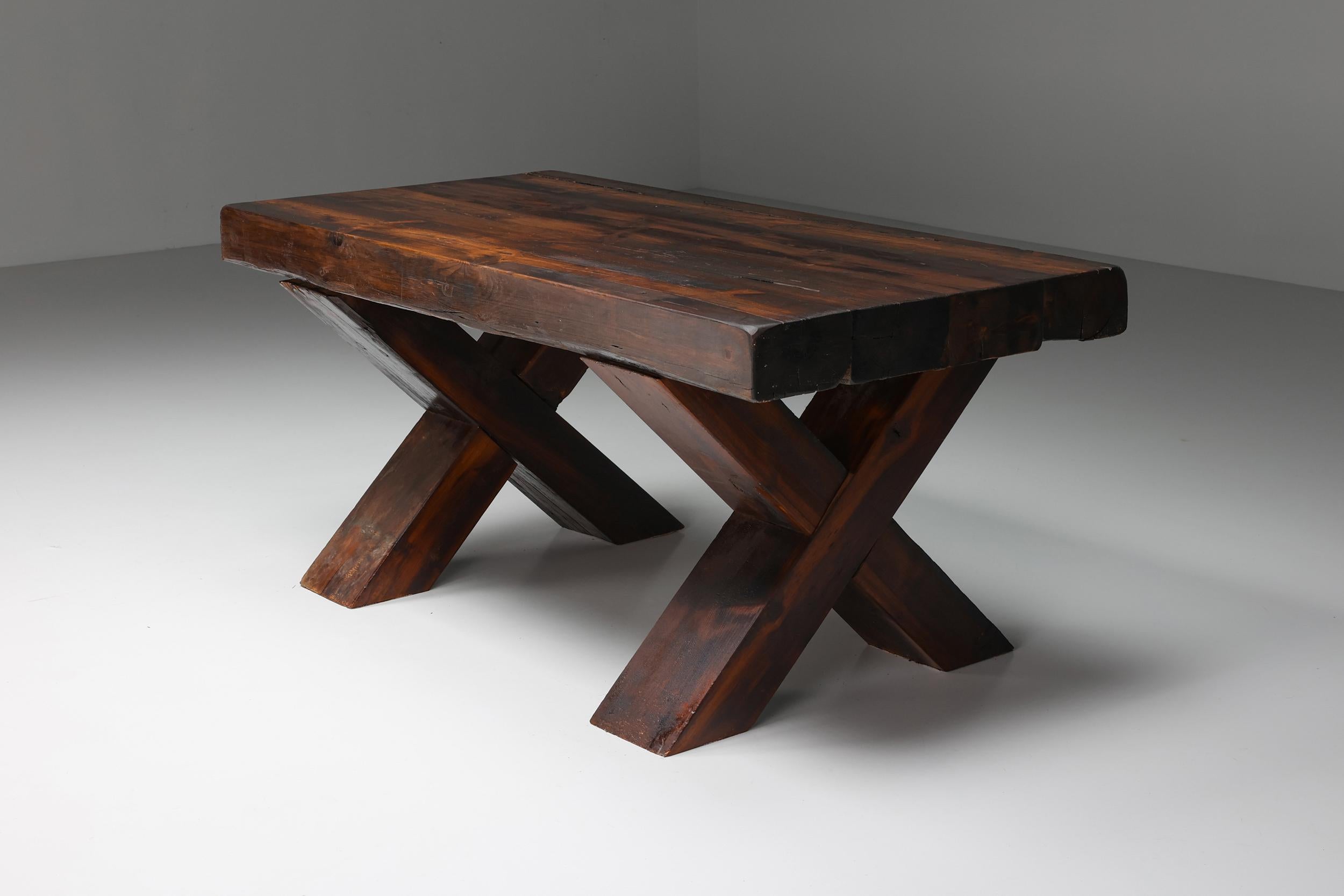 Mid-Century Modern; Italy; Rustic; Brutalist dark wooden dining table with X-legs, Italy, the 1940s; 

Rustic dark wooden dining table with X-shaped legs made in Italy in the 1940s. Seats six people comfortably. The table has a charismatic patina