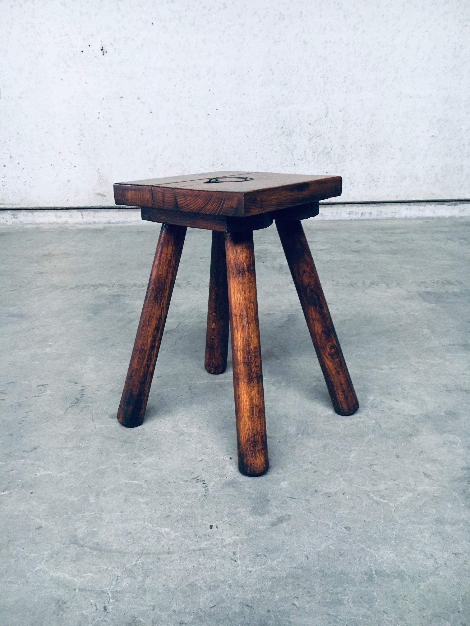 Vintage mid-century rustic Brutalist Wabi Sabi style design oak stool with metal ring handle, made in Belgium in the 1950's. Solid oak handmade constructed stool with 4 legs and metal hinged ring. In very good condition. Has been refinished; sanded,
