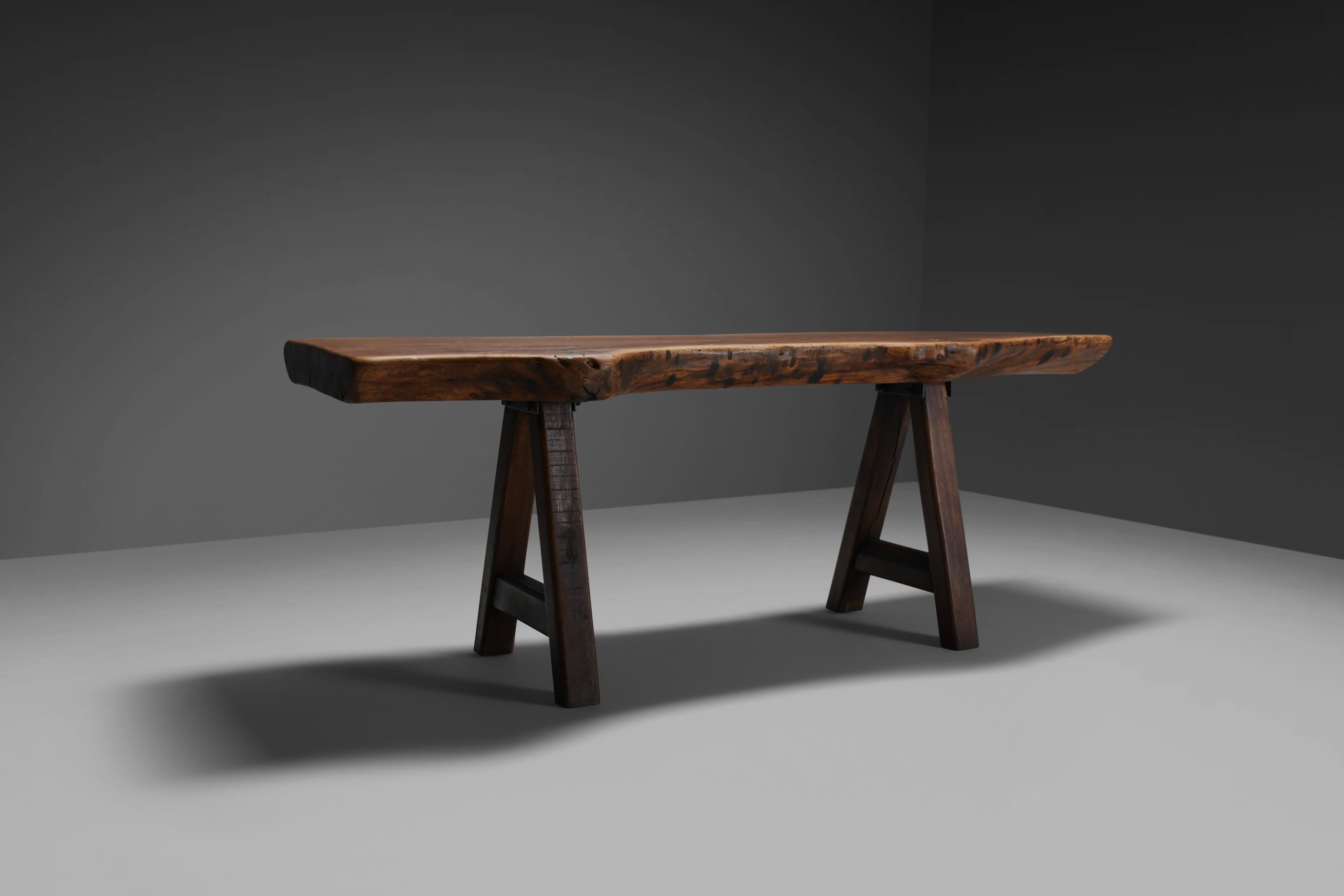 Handmade brutalist table in very good original condition.

Manufactured by Mobichalet, Belgium in the 1960s

The top is made from very heavy solid oak which was not heavily processed which results in organic and free-flowing edges.

The solid oak