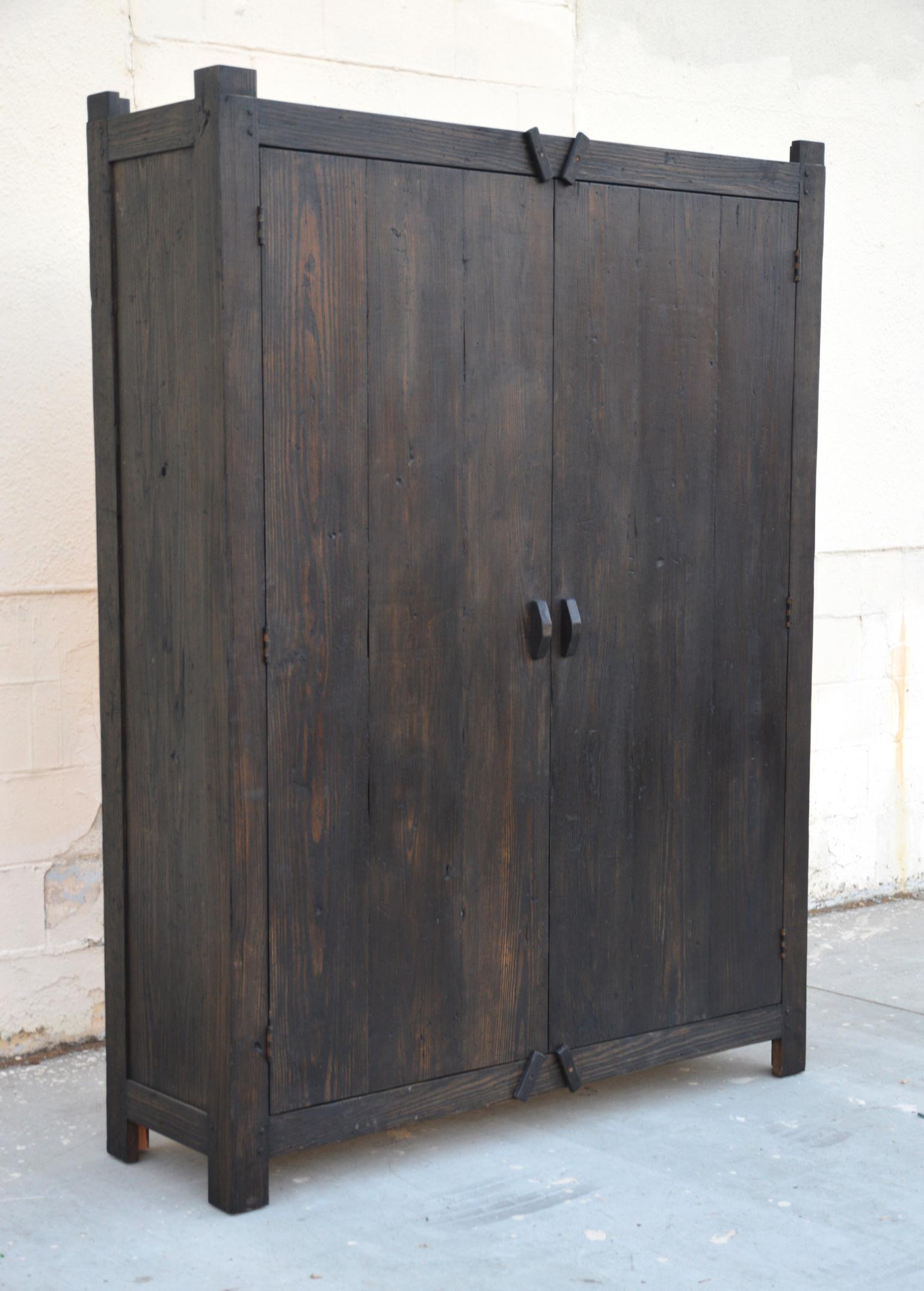 This rustic painted cabinet is made from reclaimed heart pine with adjustable shelves and planked doors. Seen here in 18