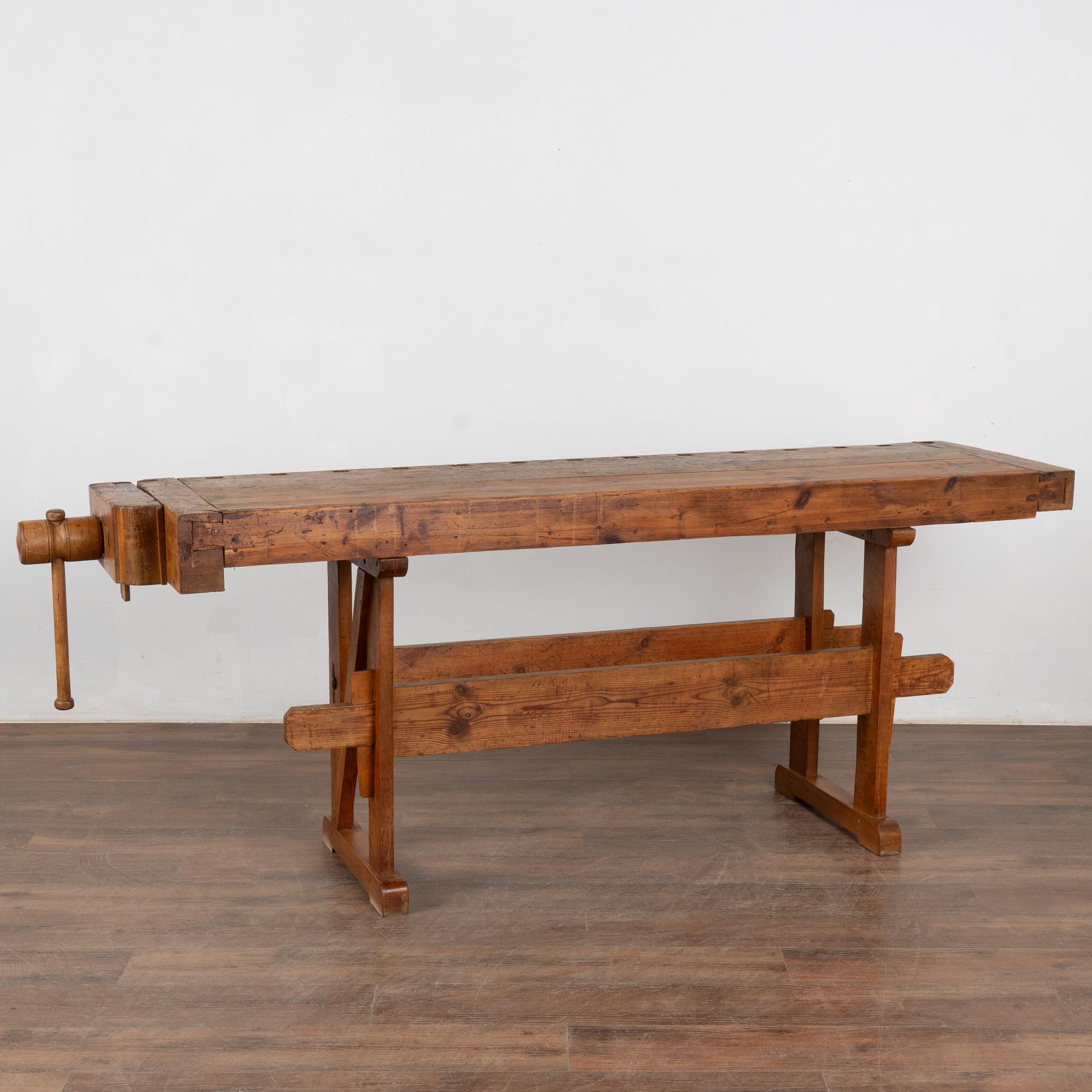 It is the years of constant use revealed in every deep gouge, ding, and scratch that enrich the character of this carpenters' workbench from Denmark.
Please examine the close up photos to appreciate the patina, joints and old hardware. 
It has one