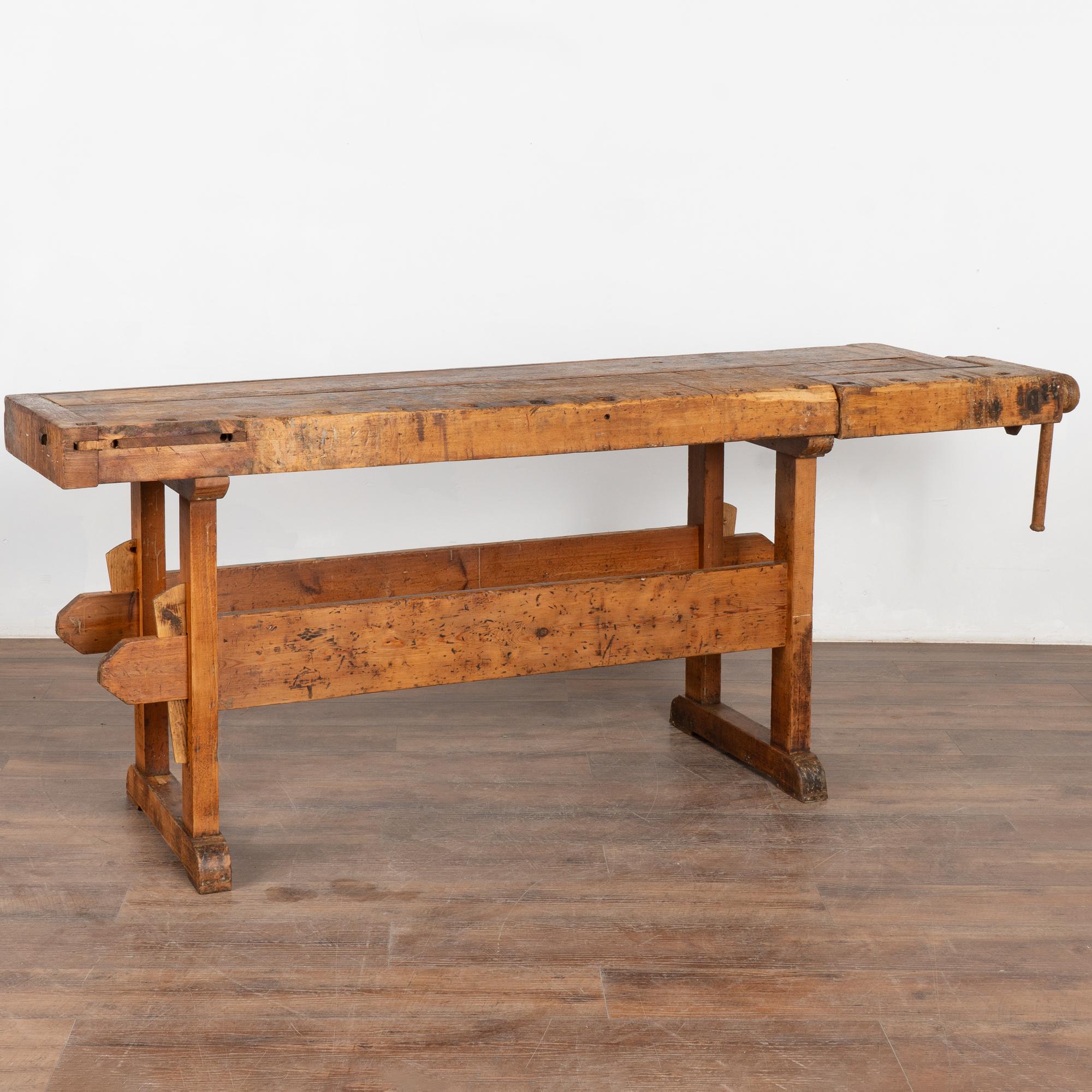 It is the years of constant use revealed in every deep gouge, ding, and scratch that enrich the character of this carpenters' workbench from Denmark.
Please examine the close up photos to appreciate the patina, joints and old hardware. 
It has one