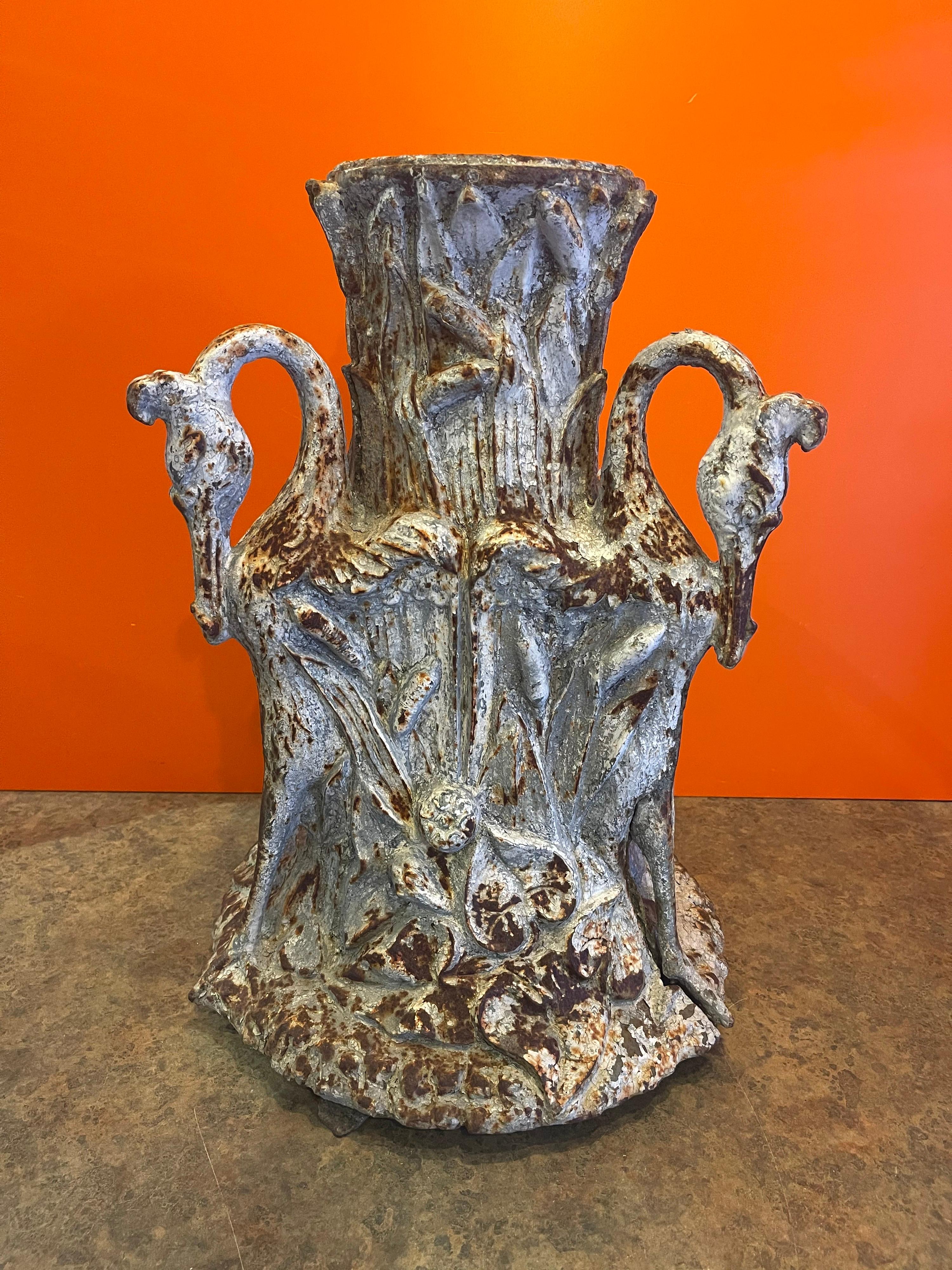 Rustic cast iron umbrella stand with swan accents, circa 1930s. The piece has a great patina, is quite heavy and measures 15
