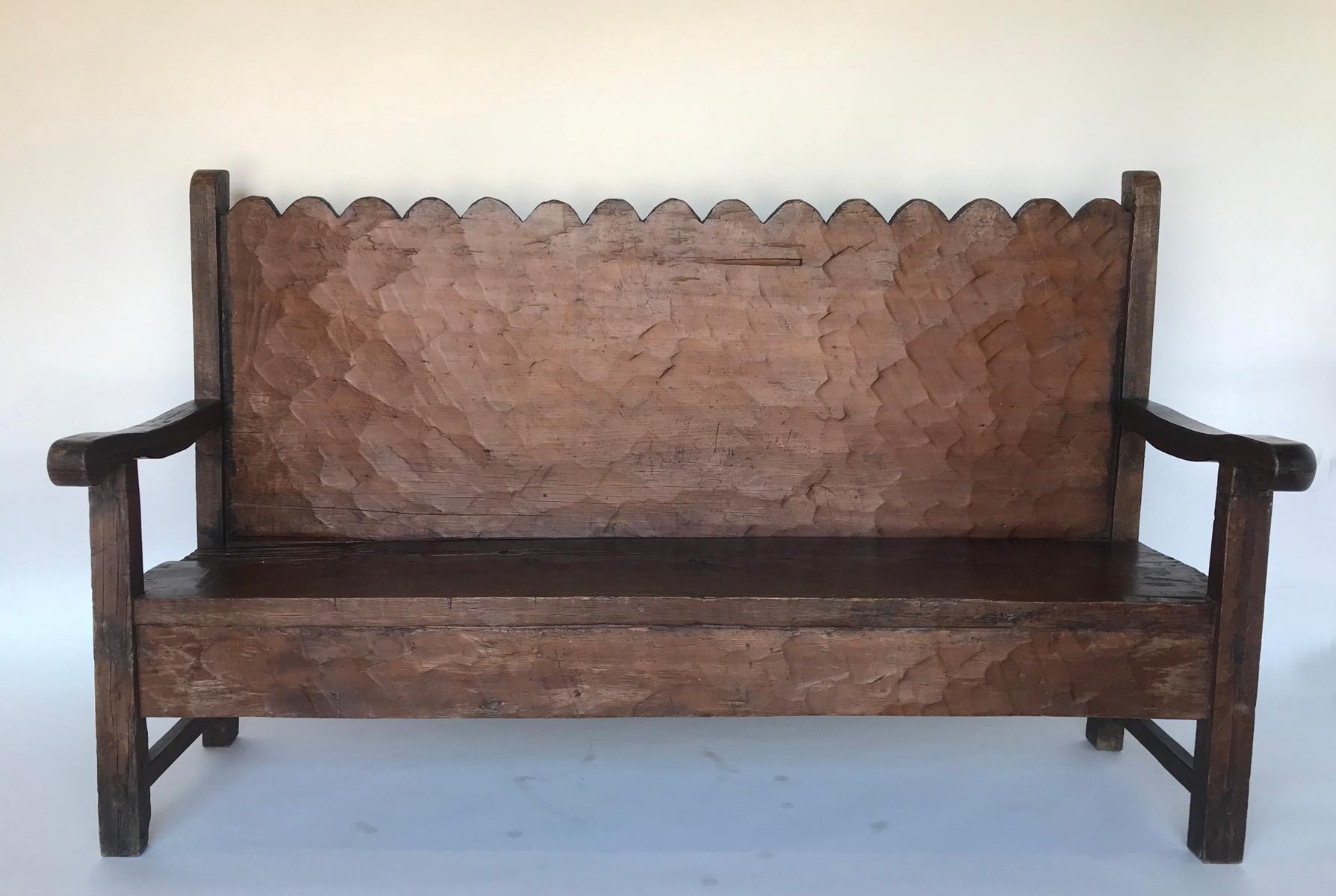 Great looking vintage Chajul bench from the highlands of Guatemala. The back consists of one wide board, traditionally hand hewn using a machete, and finished off with a series of scallops. Seat is also one wide board with a few mariposa (butterfly)