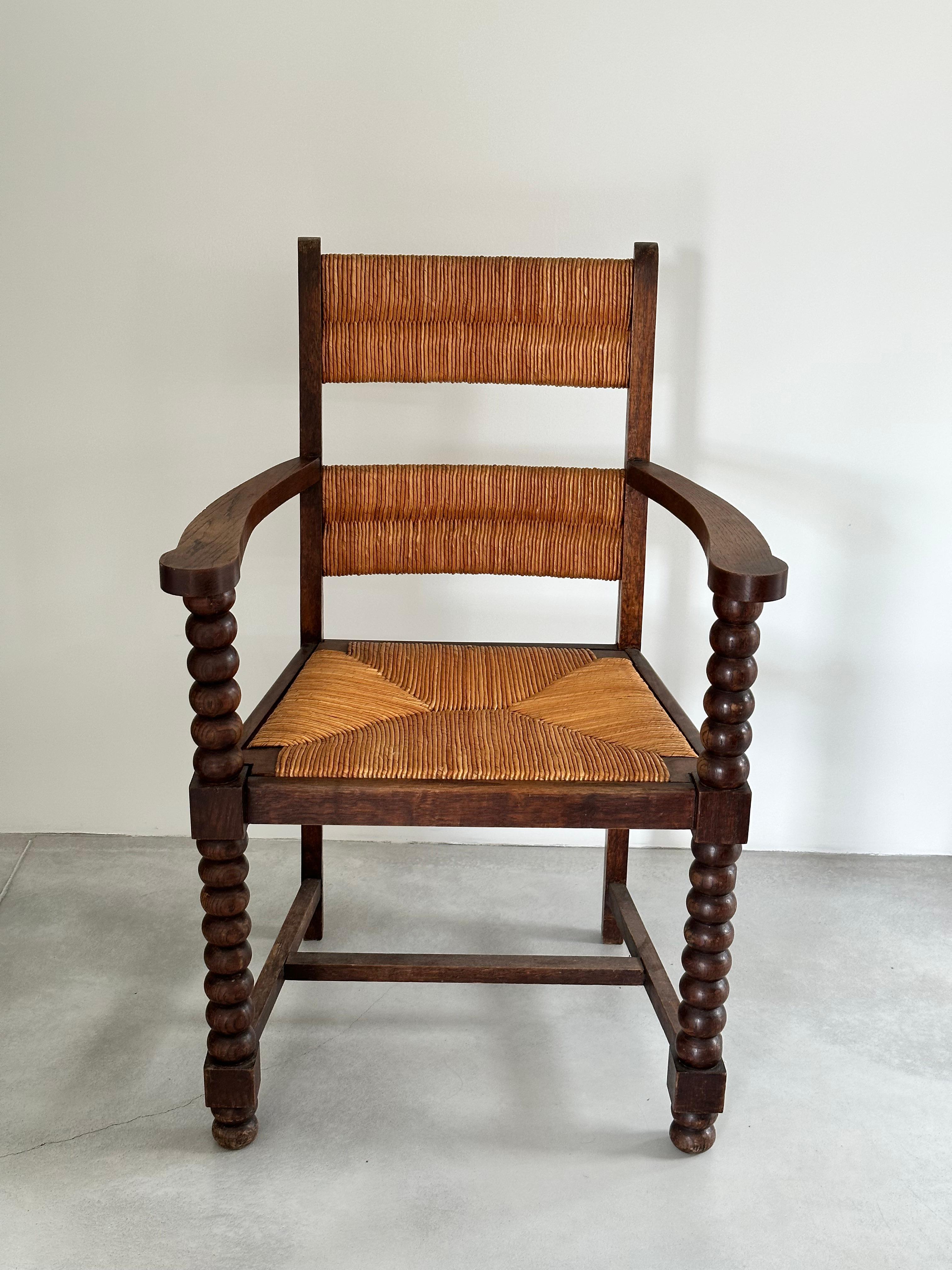 French Rustic chic armchair, stained oak, straw, Charles Dudouyt style, France 1950s For Sale