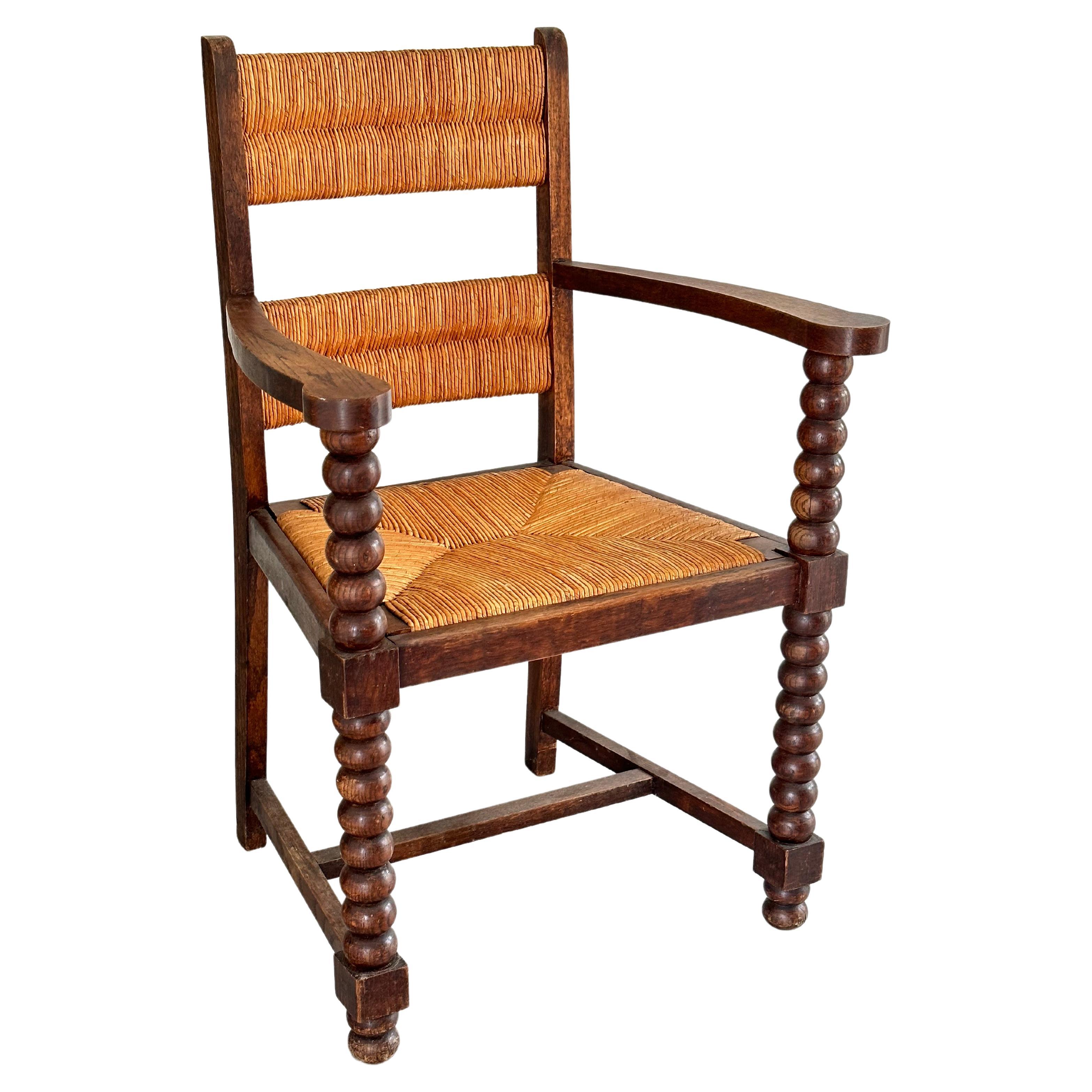 Rustic chic armchair, stained oak, straw, Charles Dudouyt style, France 1950s
