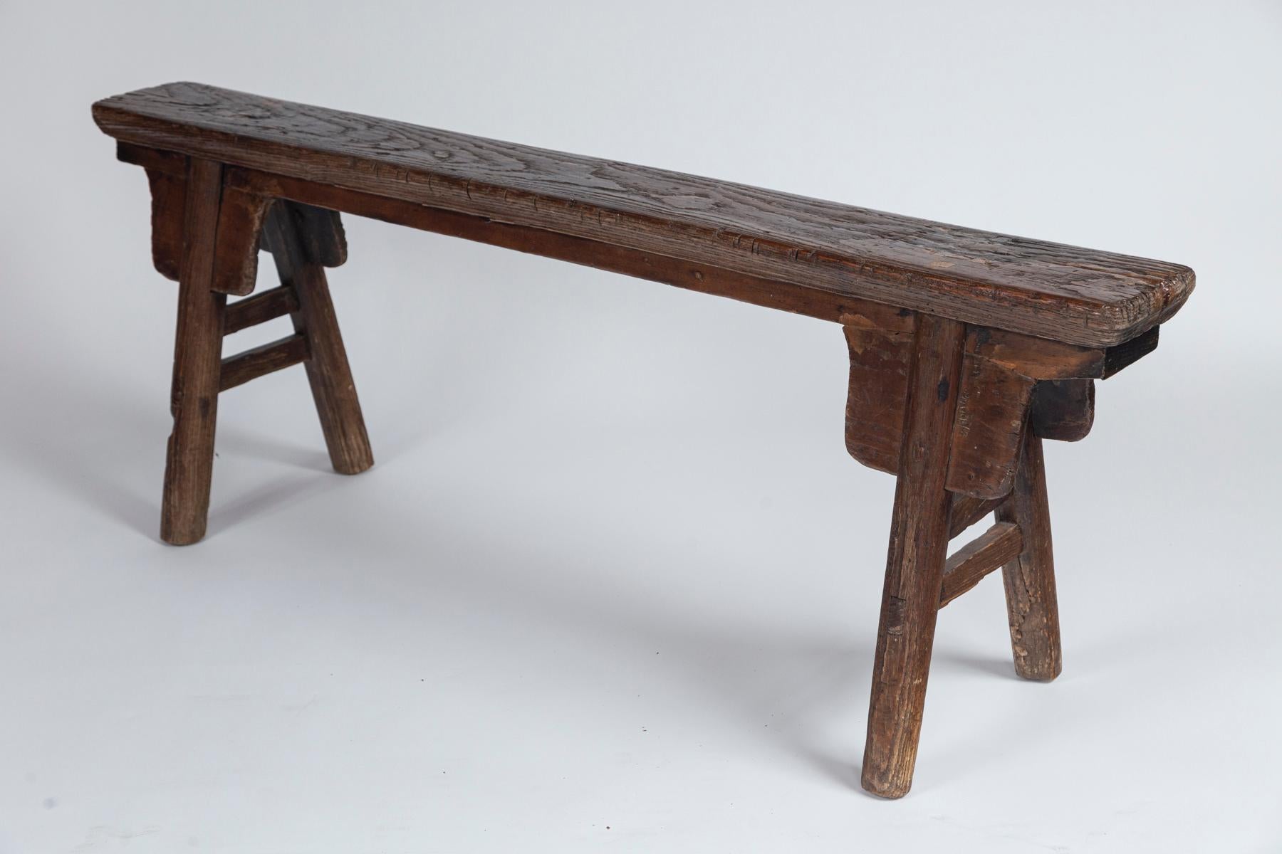 Rustic Chinese bench, 20th century. Provincial two-seat bench, hand-crafted. Aged patina.