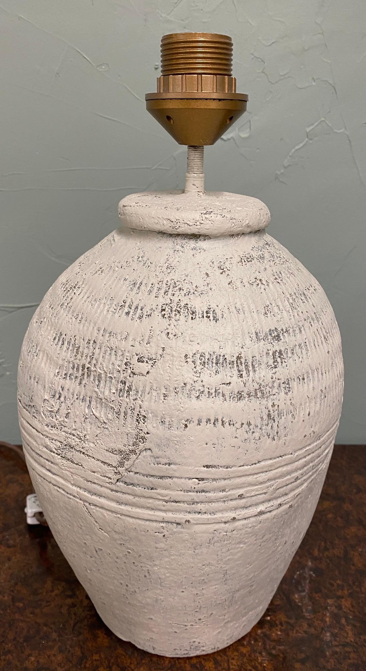 White painted, grey green terracotta lamp base made from rustic vintage Chinese clay jars used for wine storage. The lamp is hand made and was not intended for decorative use. The jar is somewhat misshapen, again because these jars in general had