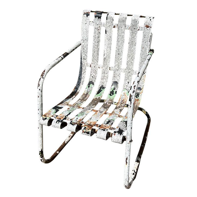 A mid-century modern metal slat patio chair. Elevate your outdoor space or patio with this rustic metal springer rocking chair. Created from metal, the chair features vertical slats that extend from the seat to the back. The rounded arms reach to