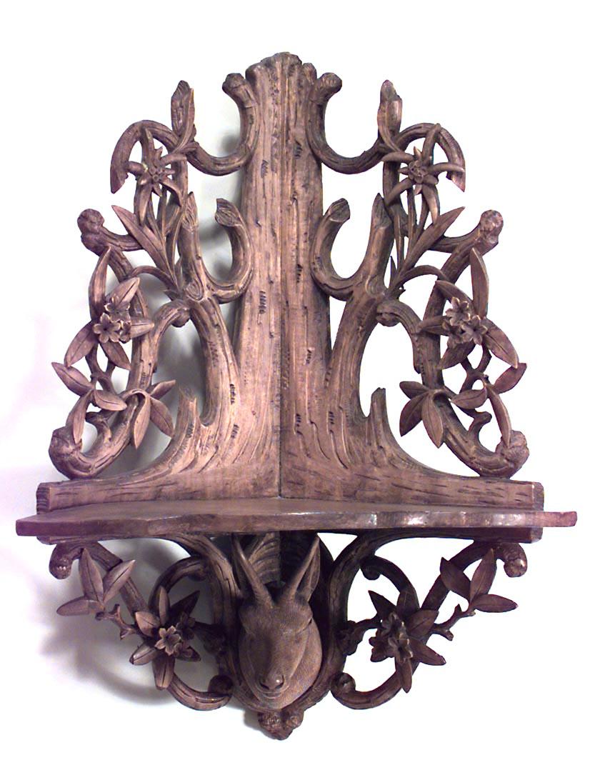 Rustic Continental 'German' stripped corner wall shelf with floral filigree and deer head carving, 19th century.
 