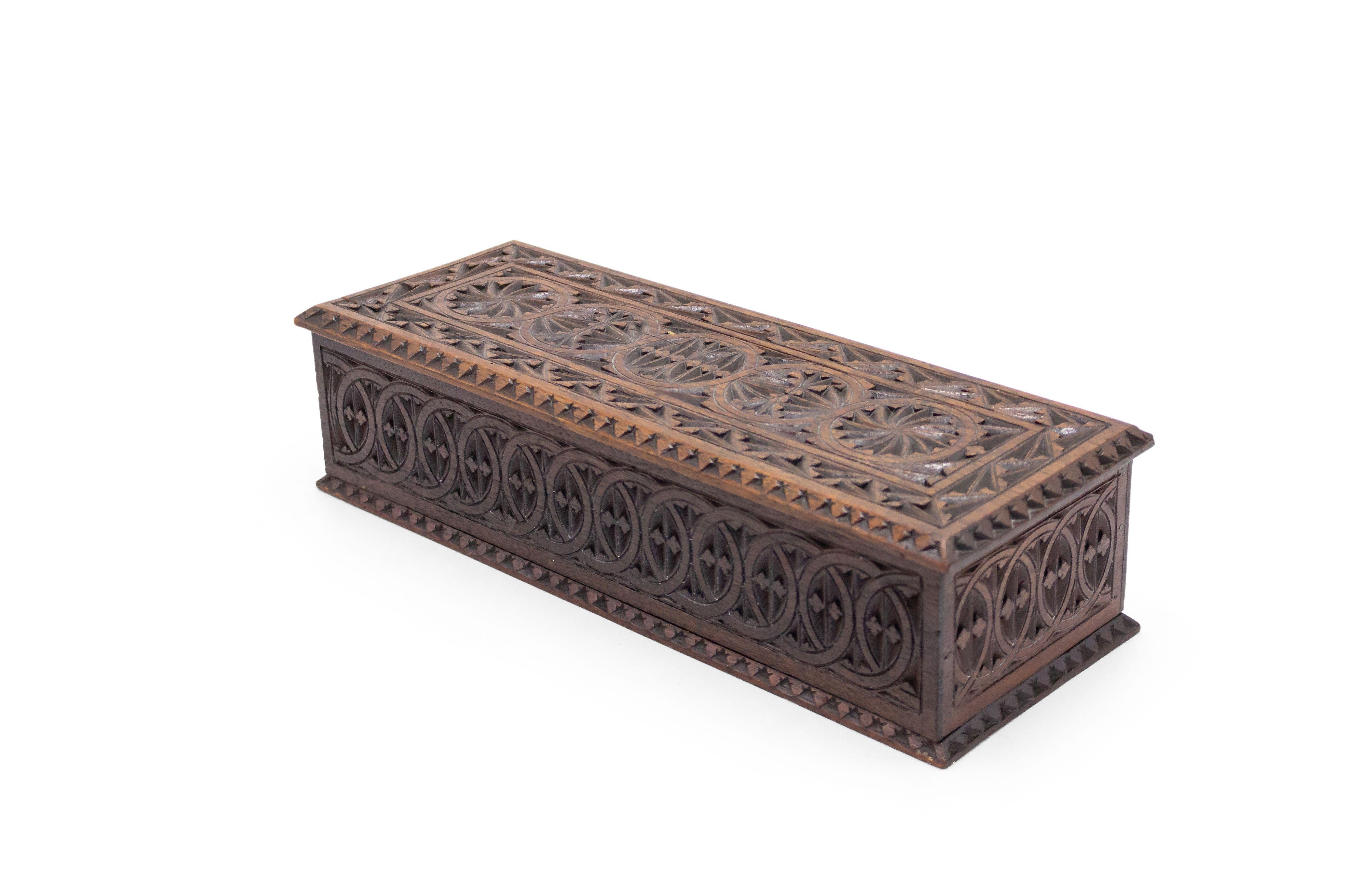 Rustic Continental mahogany rectangular box with a carved border and trim with 5 circle design top.
    