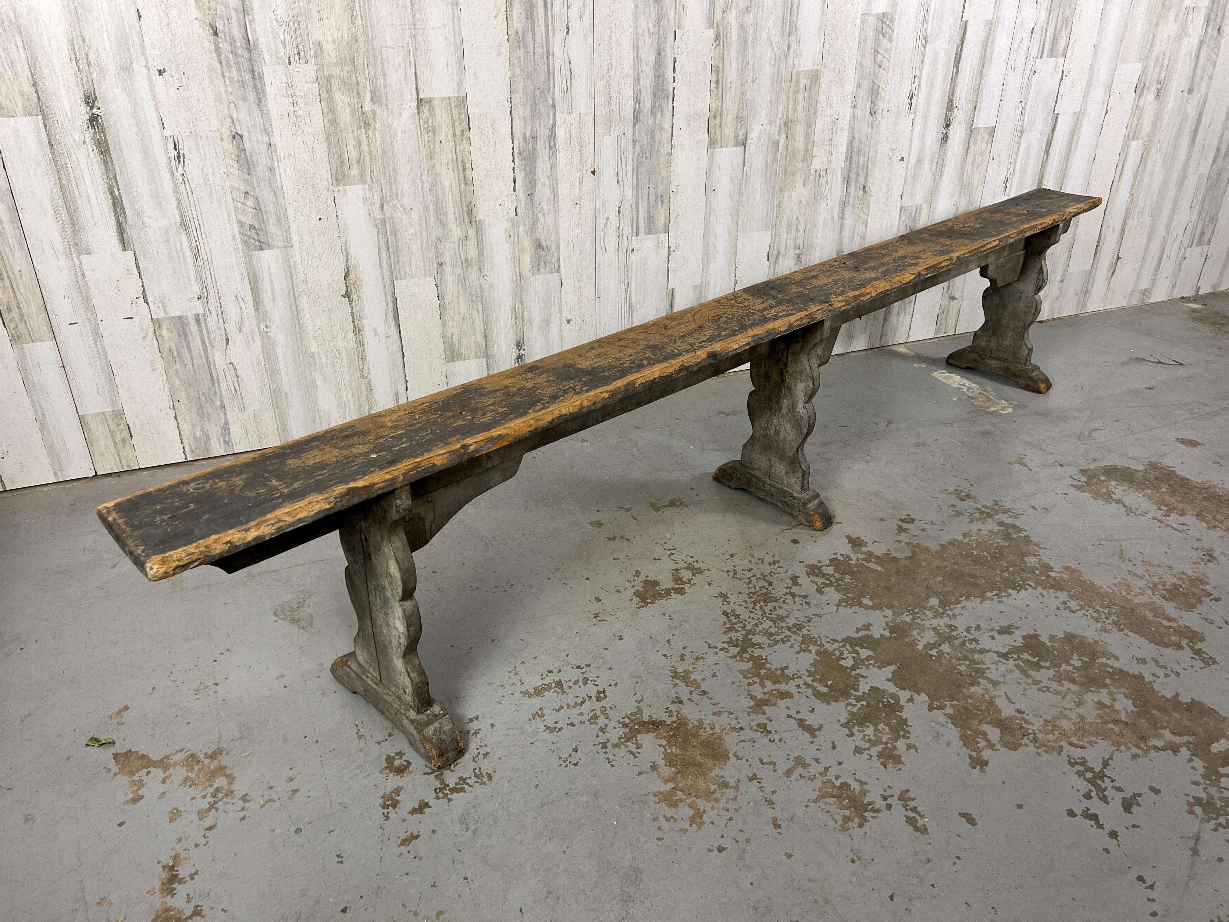 Rustic country bench made of pine with worn grey painted finish. Very sturdy can be used as seating or used to display for pottery and plants.