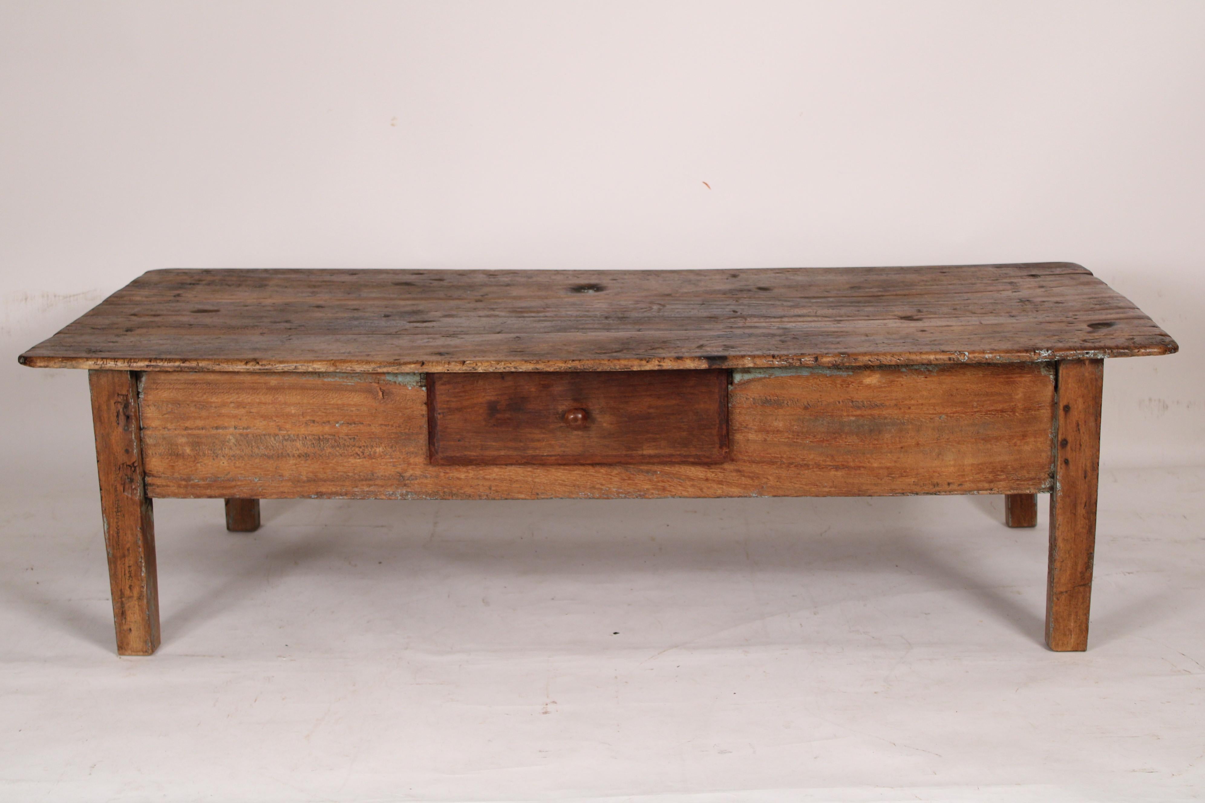 Rustic country coffee table with a drawer and traces of old paint, circa 1900.