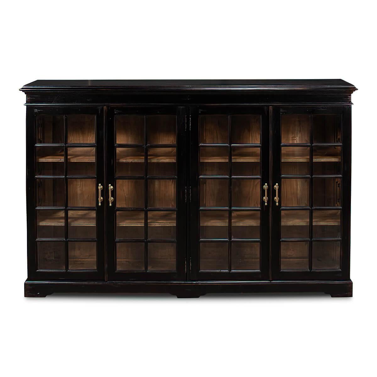 An English Rustic Country house style walnut four-door low bookcase with an antiqued and ebonized exterior, with glass doors and antiqued brass handles. With four adjustable shelves to the interior.

Dimensions
67