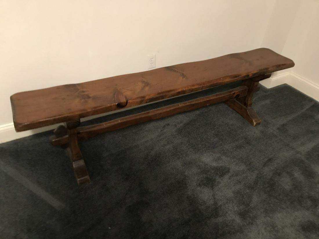Country pine farm bench stained dark with a trestle base. Use in a mud room, entry foyer or for seating at a dining table.  Please see detail photo for condition.  Bench is priced in its 