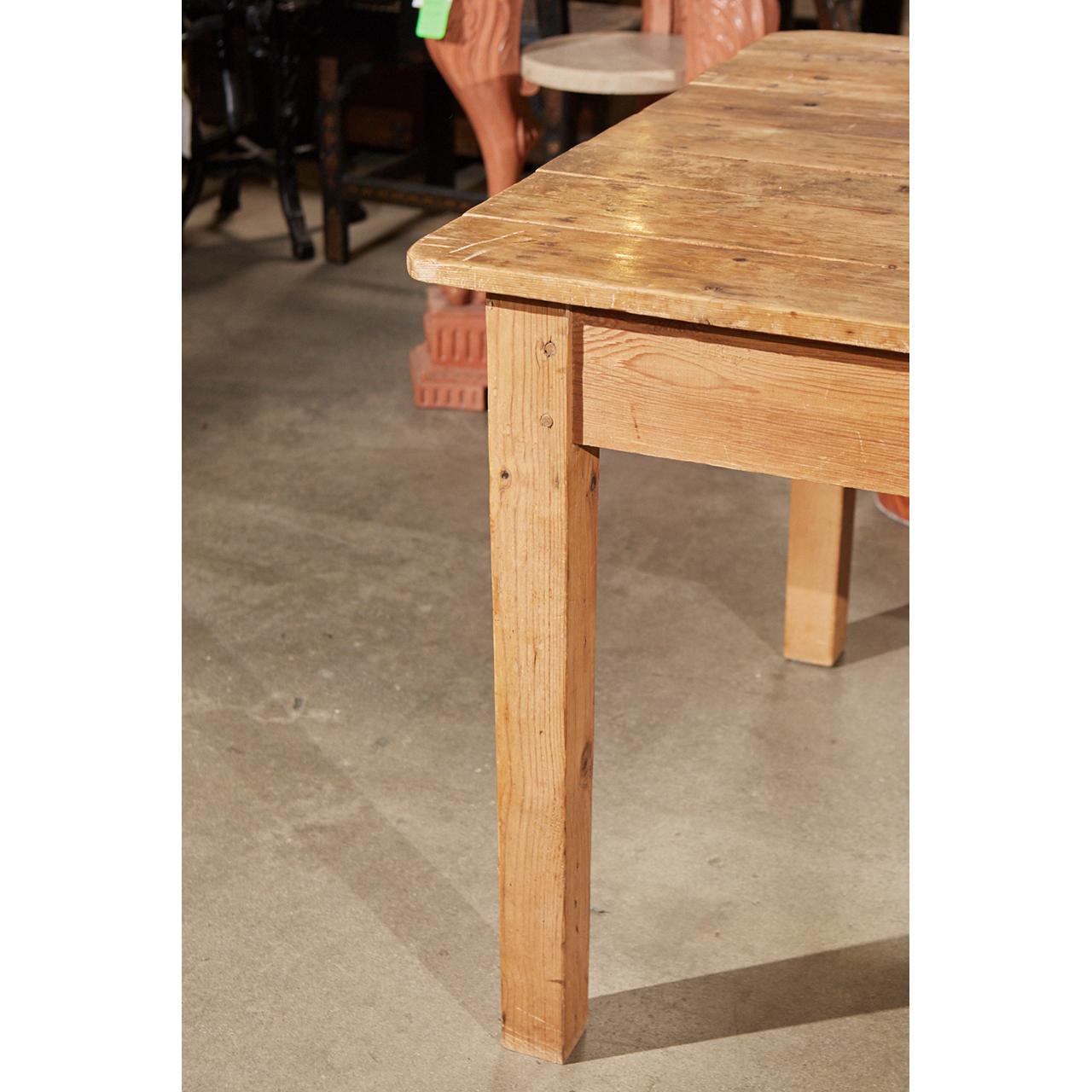 This country pine table is thought to be made in the late 19th or early 20th century in Ireland. The piece shows age and use with a well worn top and peg construction on the squared, gently tapered legs.
 