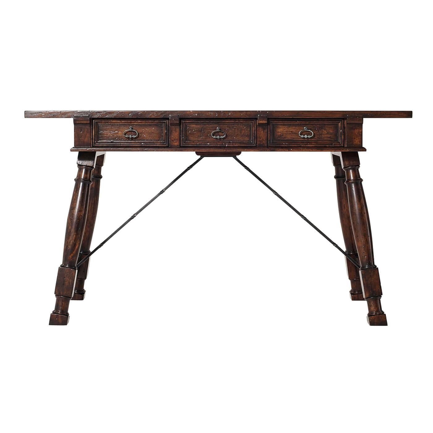 A Rustic country reclaimed oak and mahogany trestle desk, the planked rectangular top above a frieze with three recessed panel drawers, on turned column splayed end supports secured by iron stretchers.

Dimensions: 52
