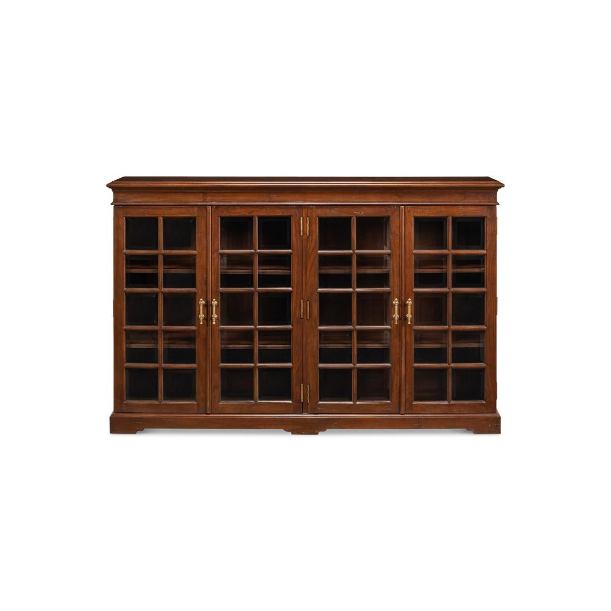 Rustic country walnut low bookcase. Step into the charming and cozy English Rustic Country house style with our exquisite walnut four-door low bookcase. The beautiful antiqued and walnut exterior of this piece is truly captivating and adds a touch
