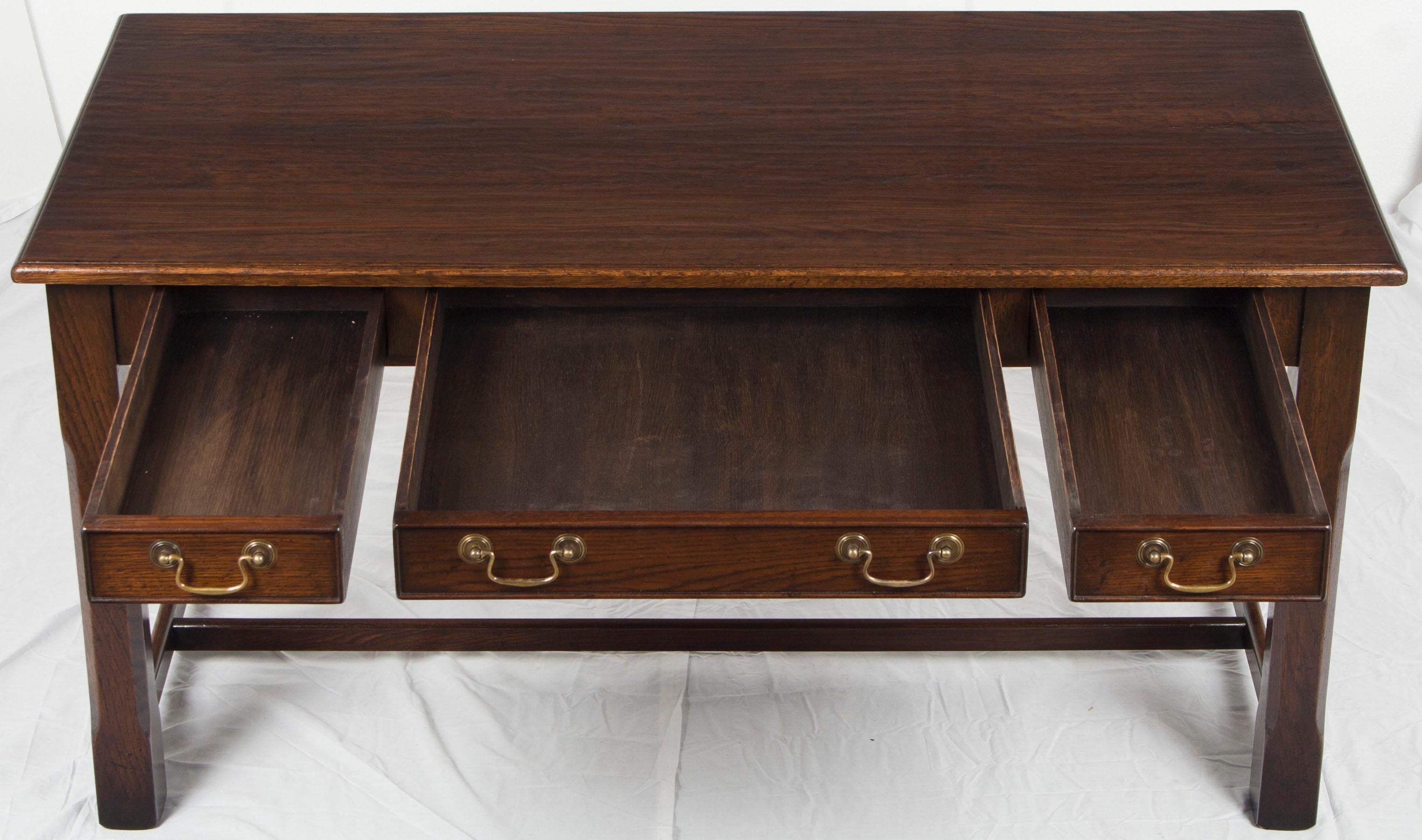 This handcrafted wood top writing desk hails from England. Recently made there, it possesses charm, character, and an heirloom quality you would expect from a master furniture craftsman. Its size allows this table desk to be a great work space in