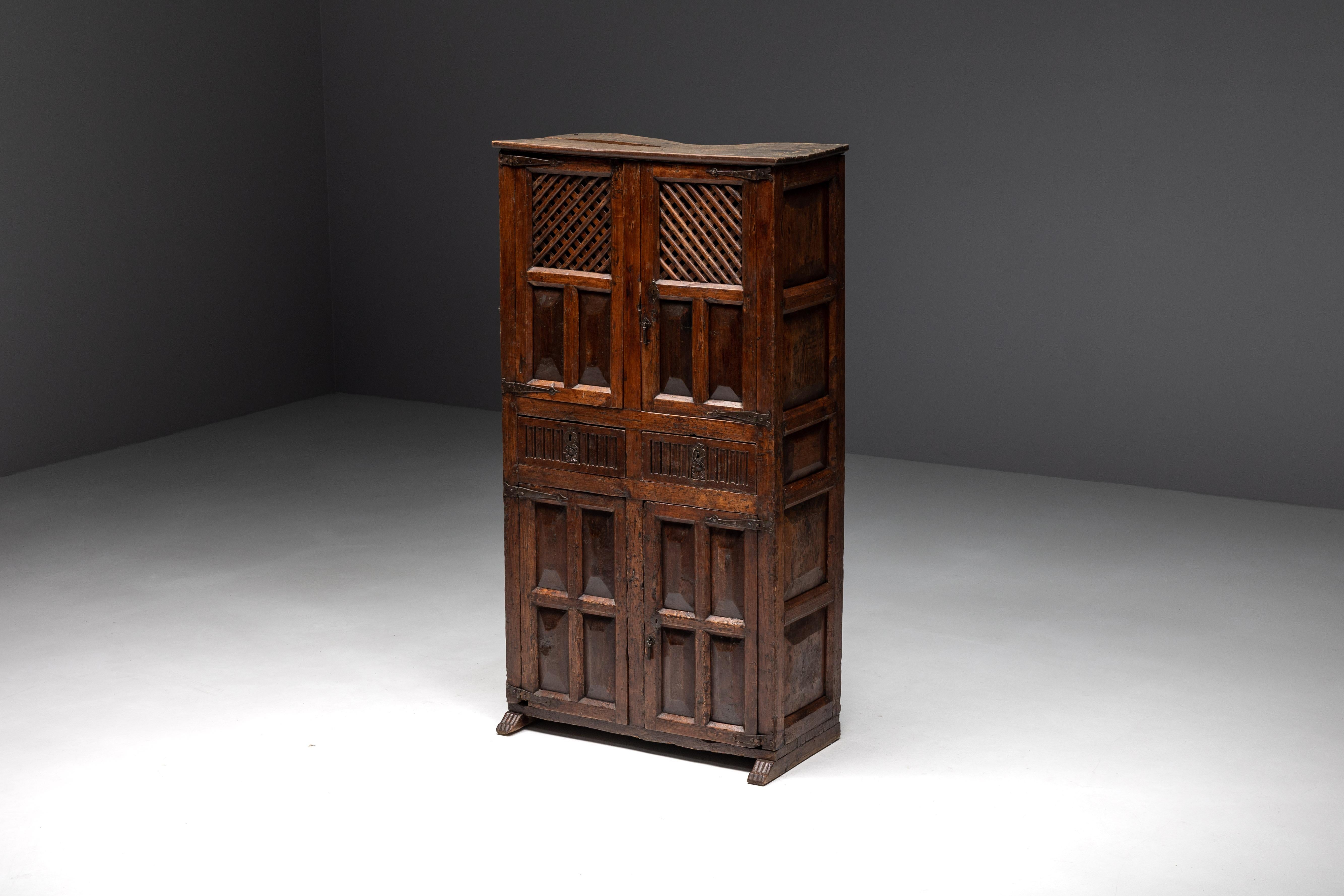 Solid dark wood pantry cabinet, a timeless masterpiece hailing from the Spanish Pyrenees, dating back to the 1800s. This stunning piece features two drawers and well-designed shelves both above and below the drawers, providing ample storage for your