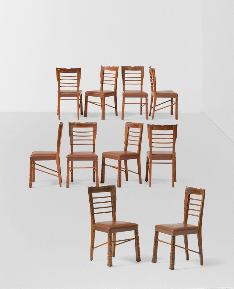Vittorio Valabrega Rustic Primitive Dining Chairs, Set of 10

This is an extremely rare set of rustic Deco chairs. Their appearance is both heavy and light thanks to the ladder back. Carved in Oak, the ladder back terminates in a well delineated