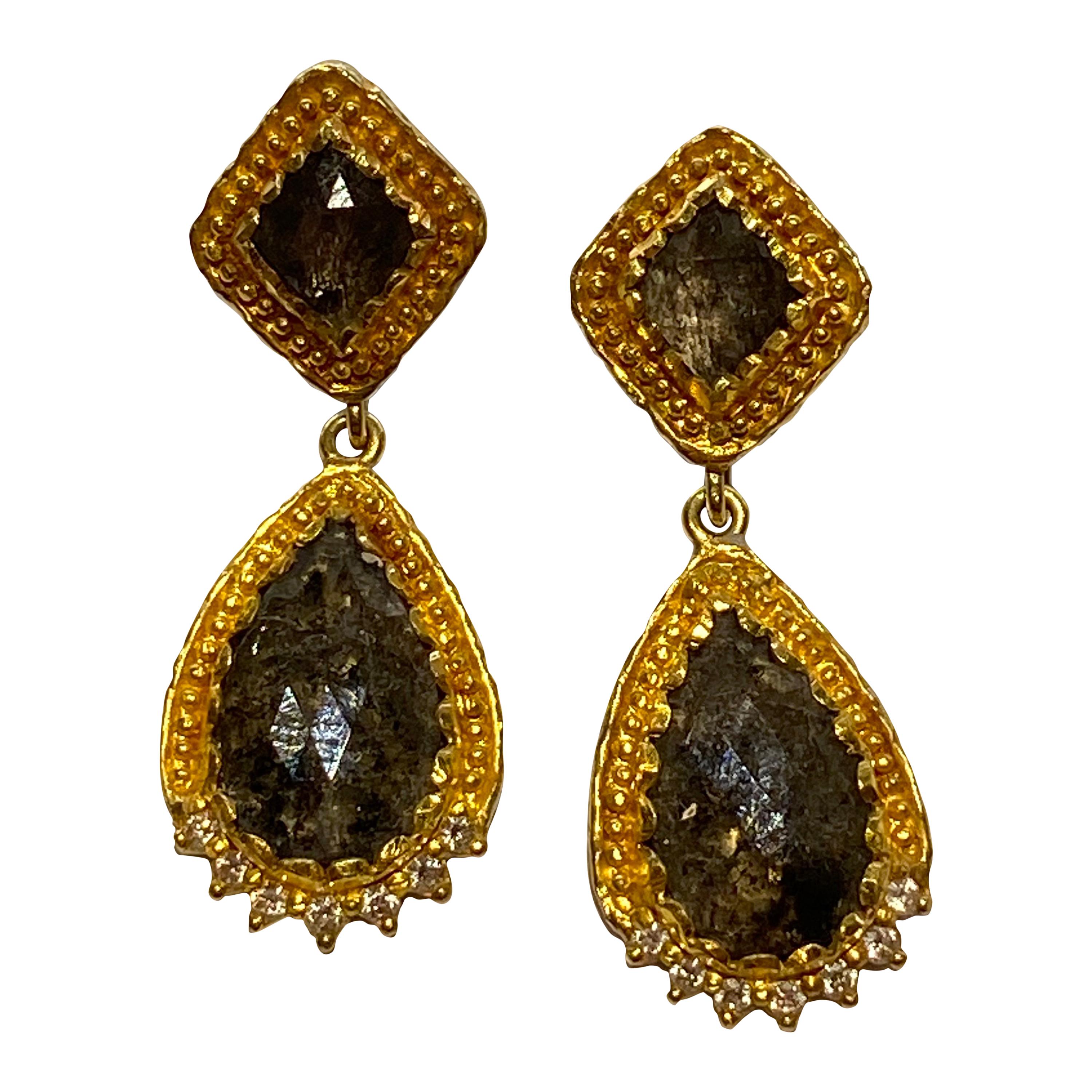 Inspired by the energy pulsating throughout nature, Velyan unites pure metals and gemstones into stunning styles that display the grandeur of fine jewelry.

These earrings feature rustic diamonds teardrops set in 24k yellow gold with pave white