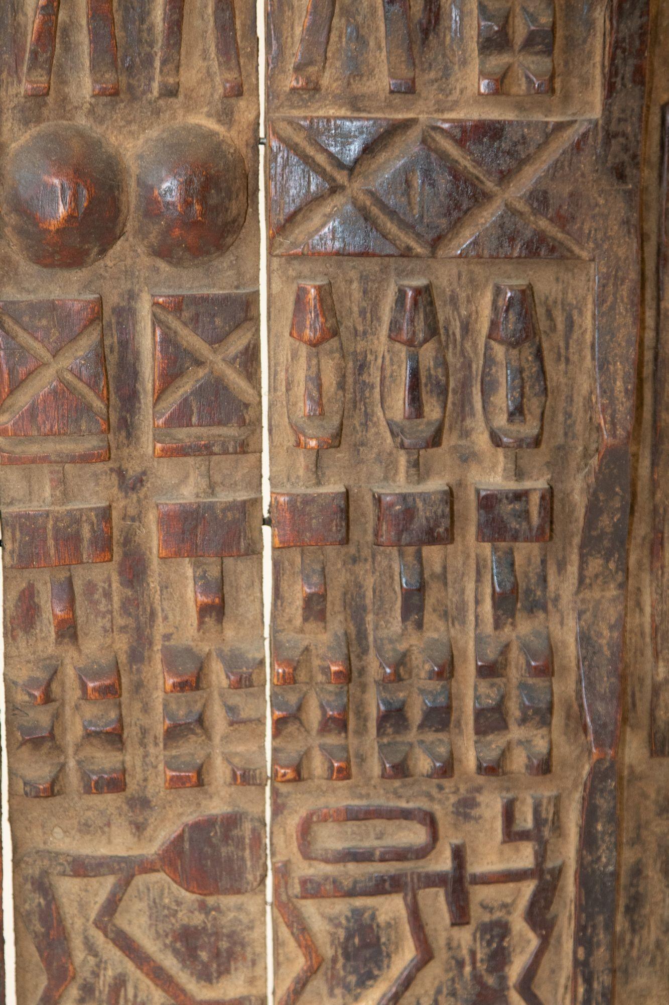 African granery Dogon style door Sculpture with figures, from Mali.
This is an amazing piece of African Folk Art of a quickly disappearing ethnic group, functioning as a decorative mounted hand carved piece of art.
Fantastic hand carved African door