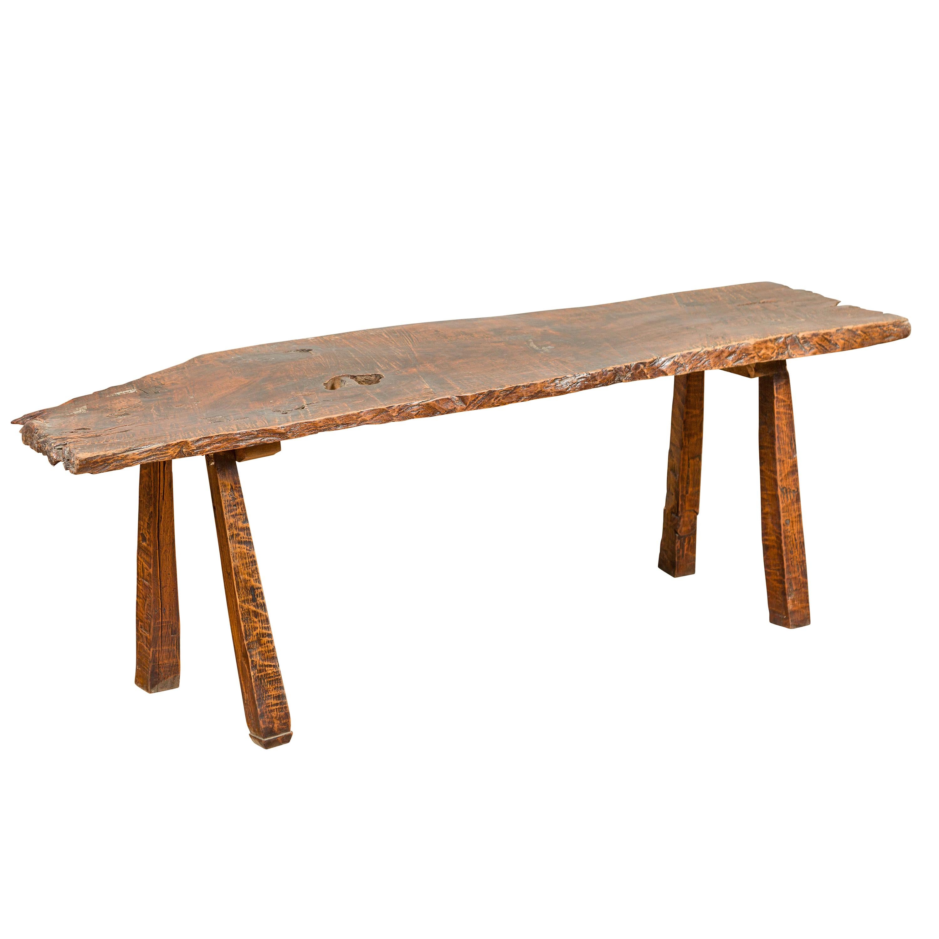 Rustic Driftwood Bench with Weathered Appearance and Splaying Legs