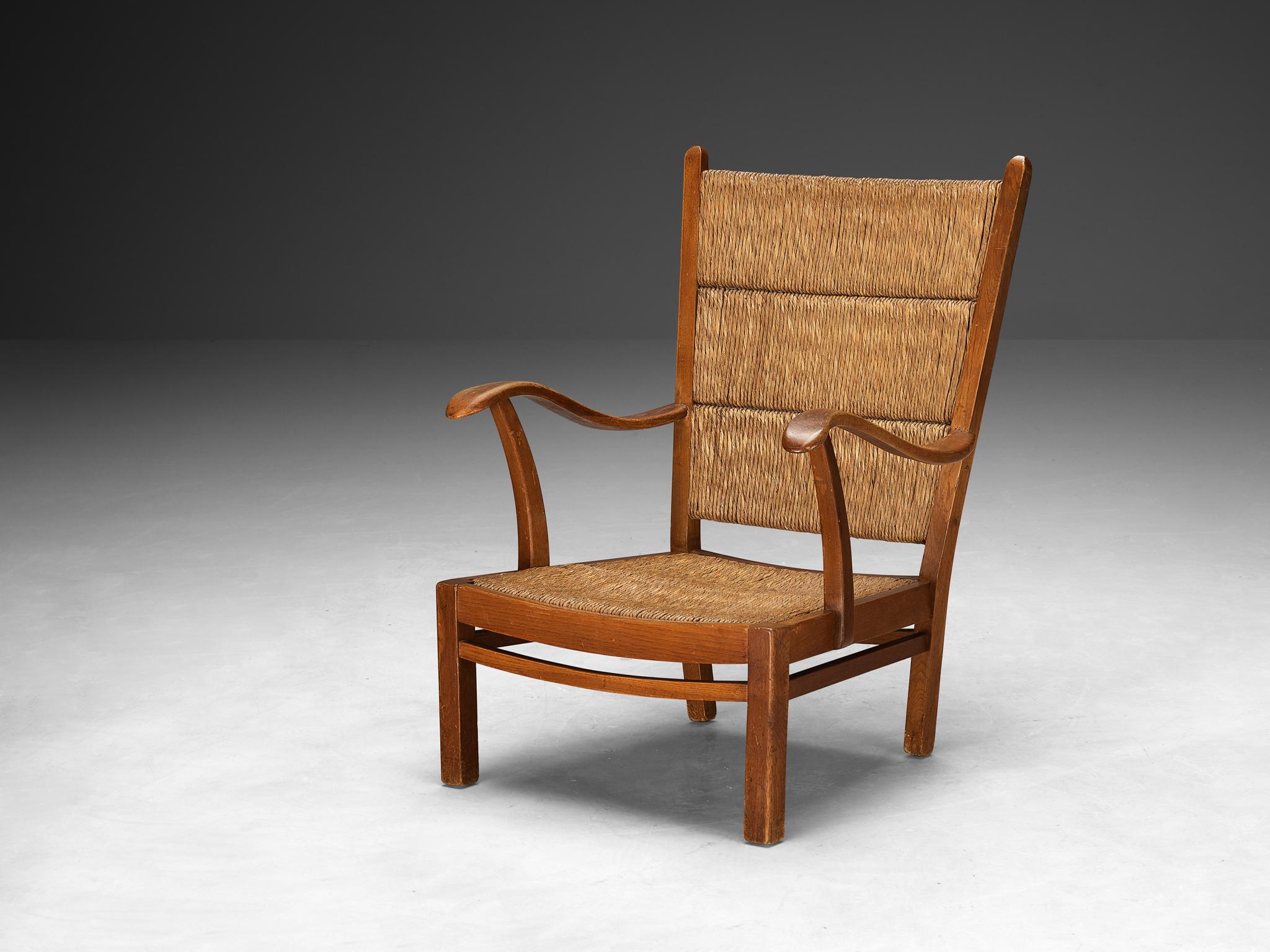 Armchair, straw, stained beech, The Netherlands, 1950s

This rustic armchair originates from The Netherlands and epitomizes an exquisite simplicity of remarkable quality. The straw backrest is made in three parts and shows horizontal openings that