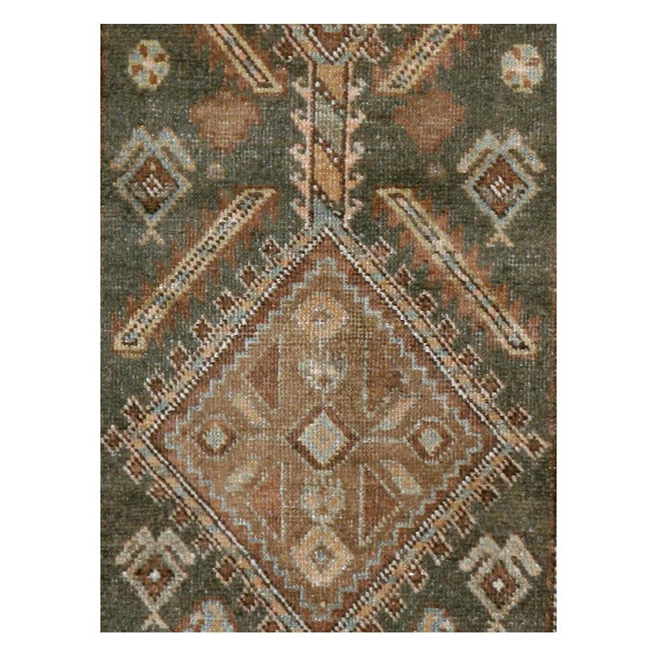 An antique Persian Kurd rug in runner format handmade during the early 20th century with a rustic appeal in khaki green.

Measures: 3' 0