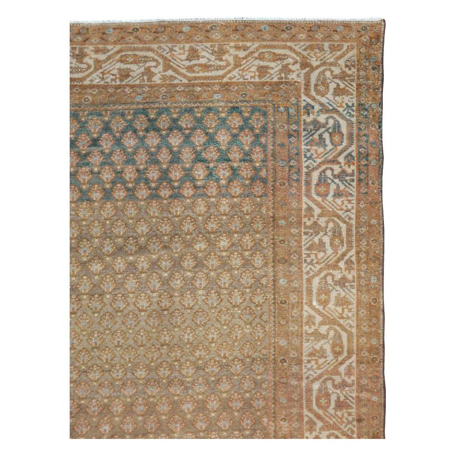 An antique Persian Malayer gallery format rug handmade during the mid-20th century. This rustic piece has an all-over paisley design over a subtly abrashed (natural variations in color) field in earth tones.

Measures: 5' 3